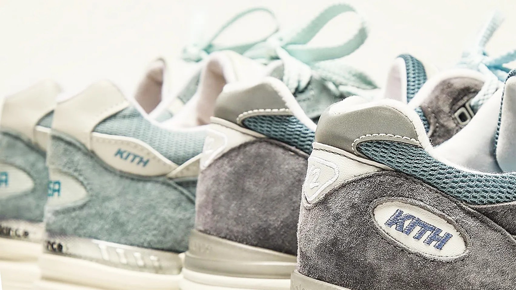 the heels of two pairs of blue Kith x New Balance running shoes