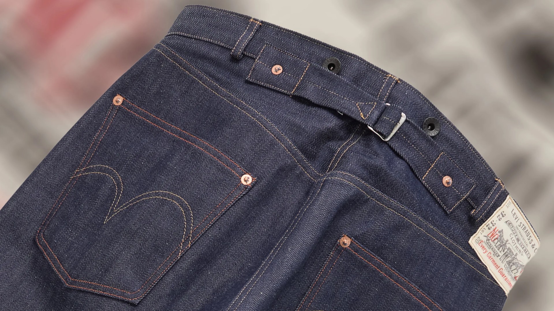 the back pocket and waist cinch on a pair of Levis jeans