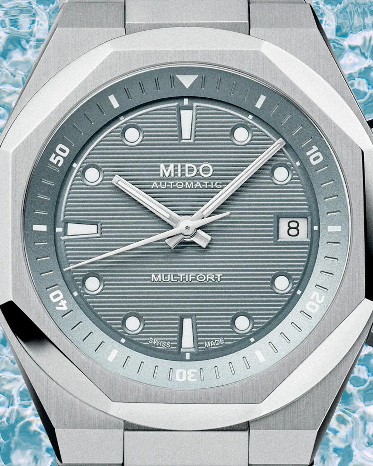 close up of the dial on a Mido steel dive watch