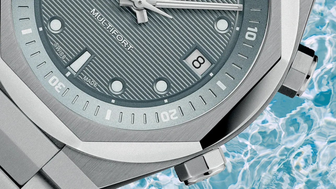 the dial, crowns and bezel of a steel watch