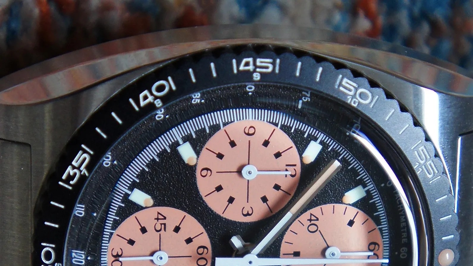 the bezel and dial of a chronograph watch