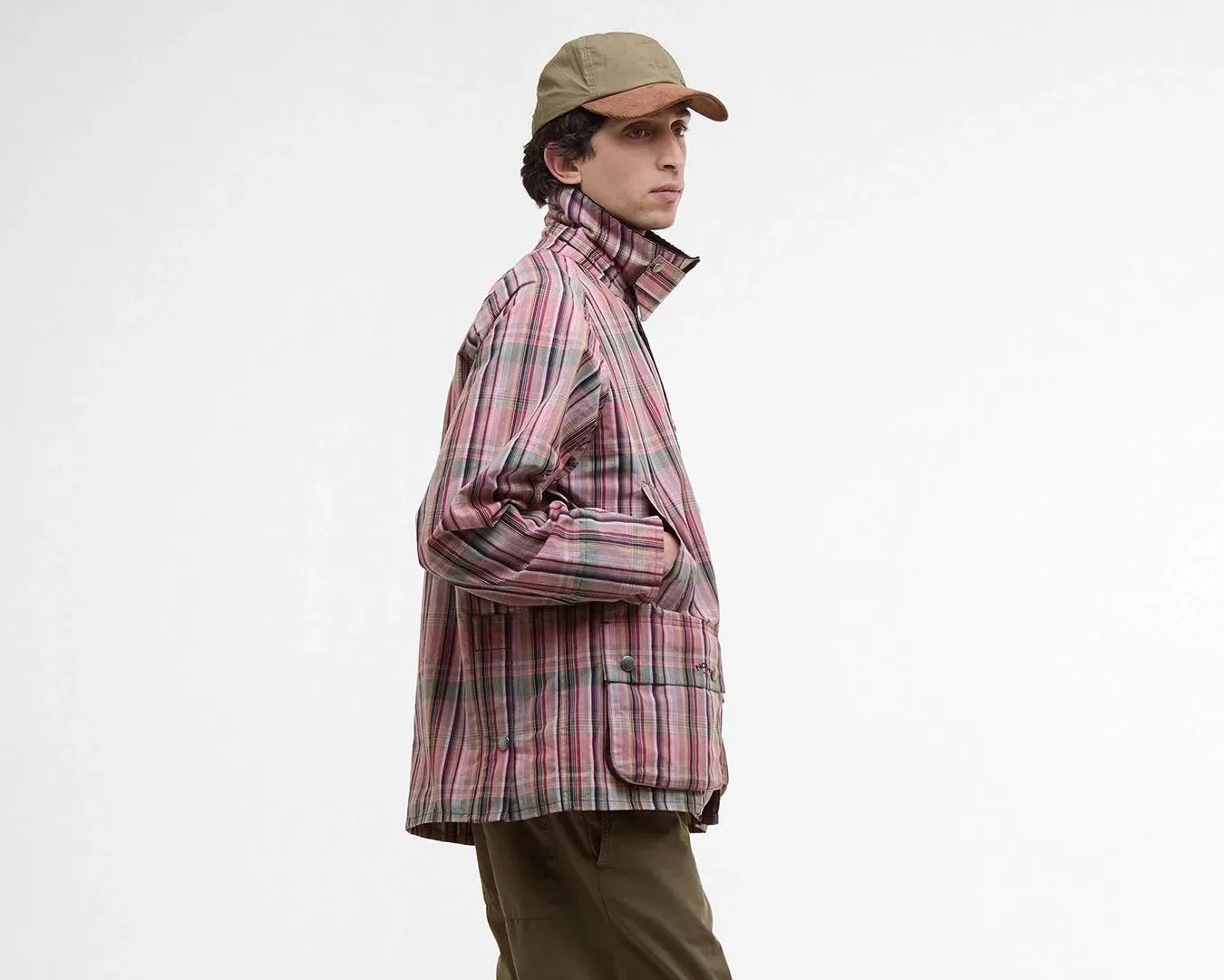 a man in a pink plaid jacket and tan hat