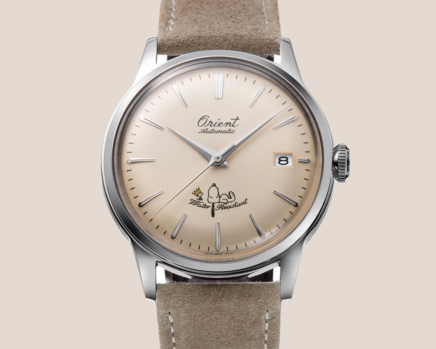 a cream dial dress watch with Snoopy and Woodstock on it