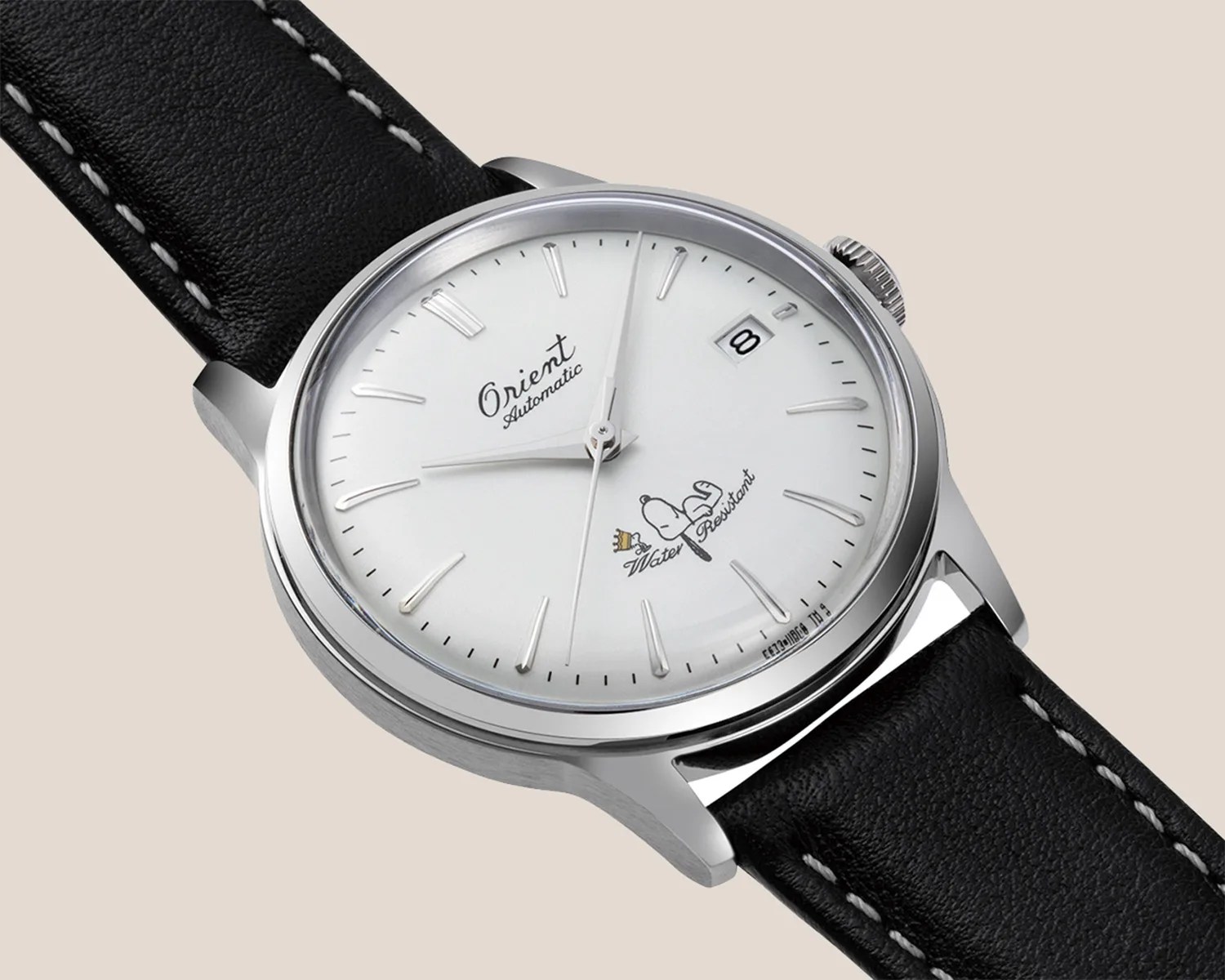 a white dial dress watch with Snoopy and Woodstock on it