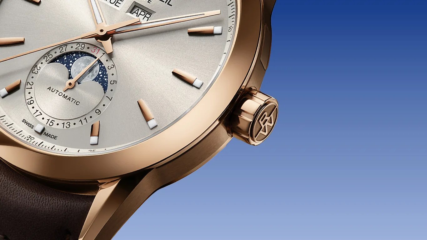 a closeup of a raymond weil calendar watch