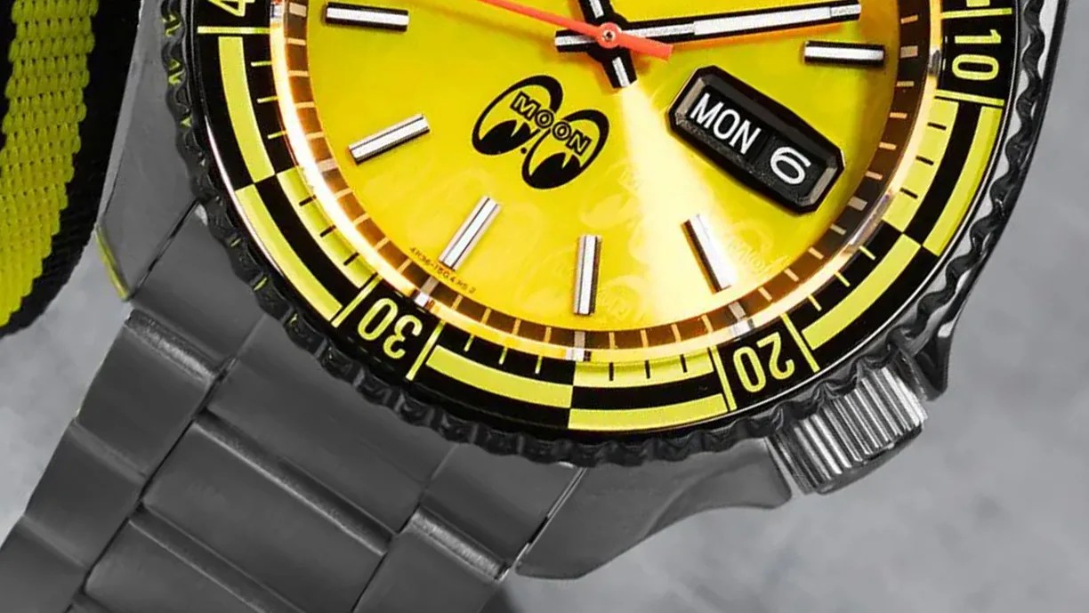 the dial and bezel of yellow Seiko 5 Sports watch