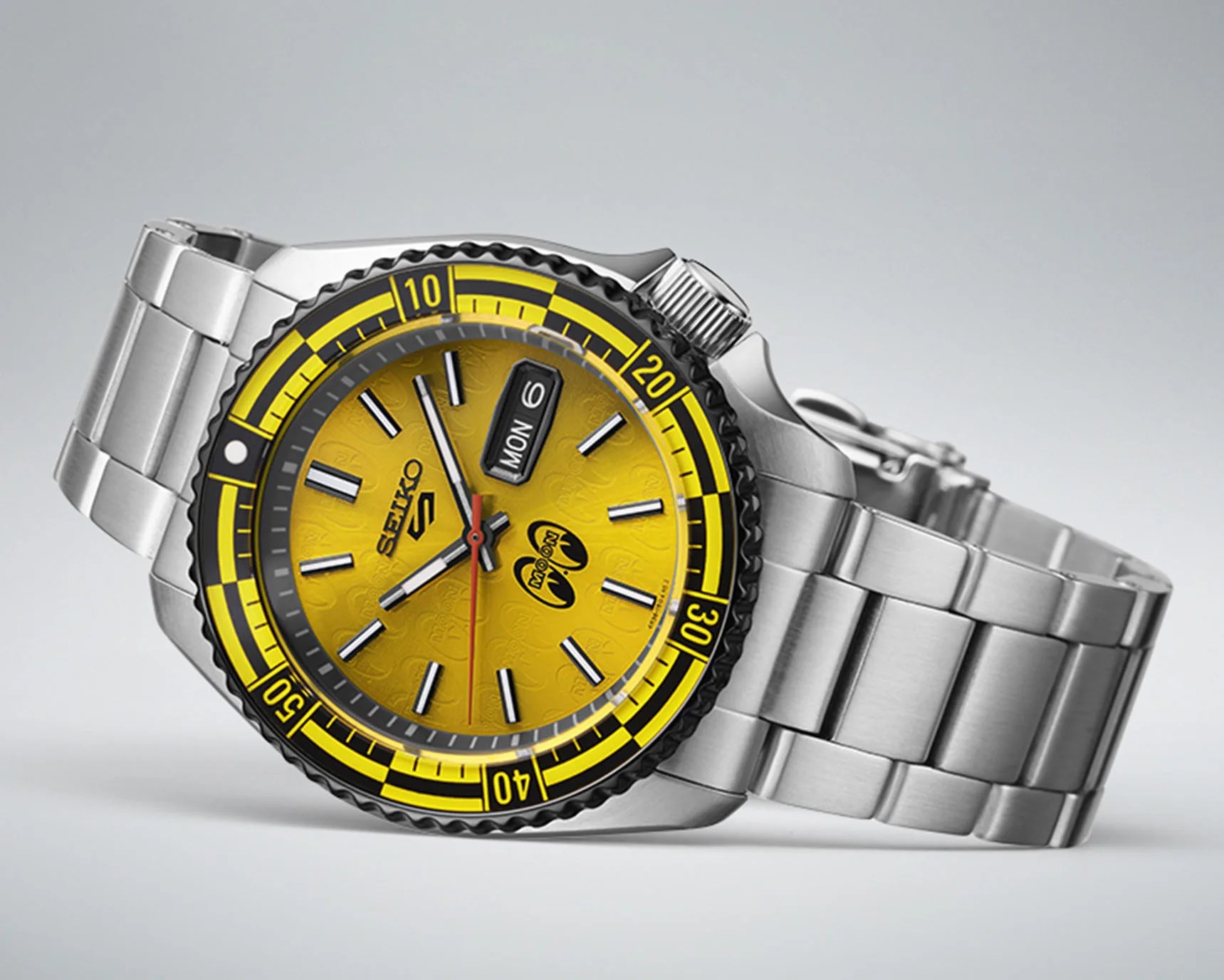 a yellow dial sports watch with a steel bracelet