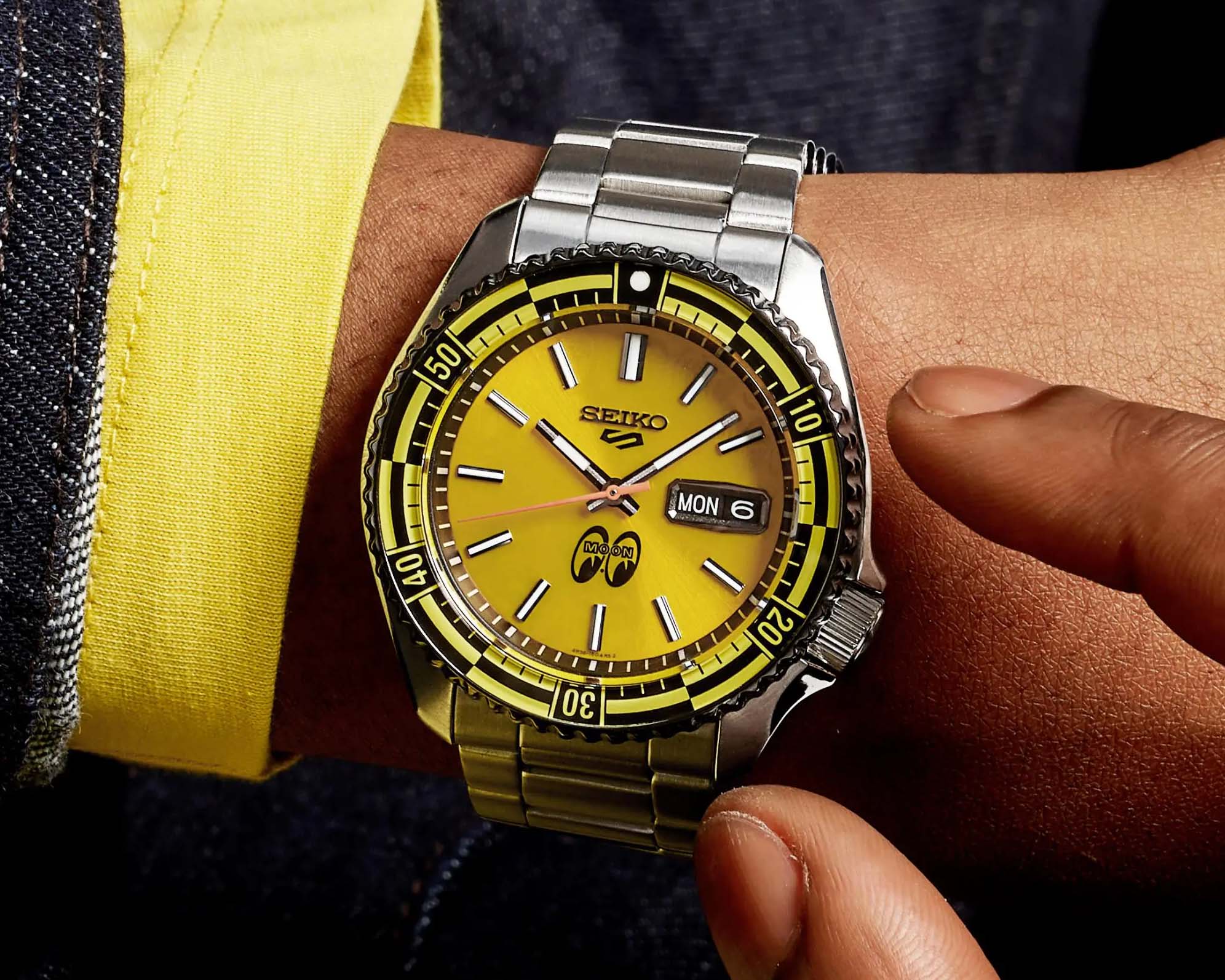 a yellow dial watch on a man's wrist