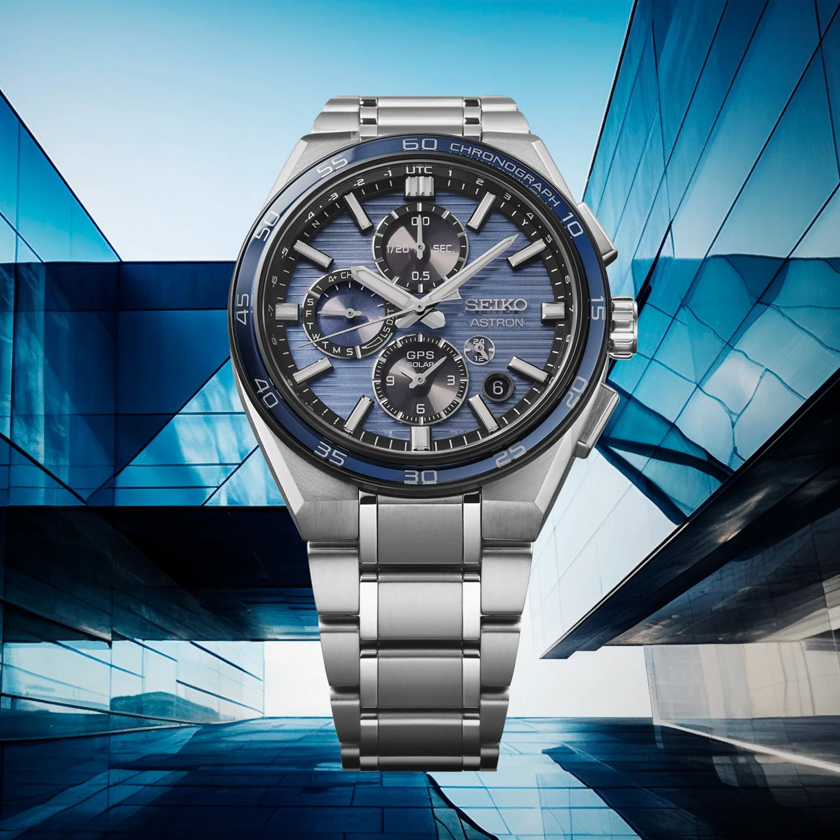 a blue Seiko chronograph with a building in the background