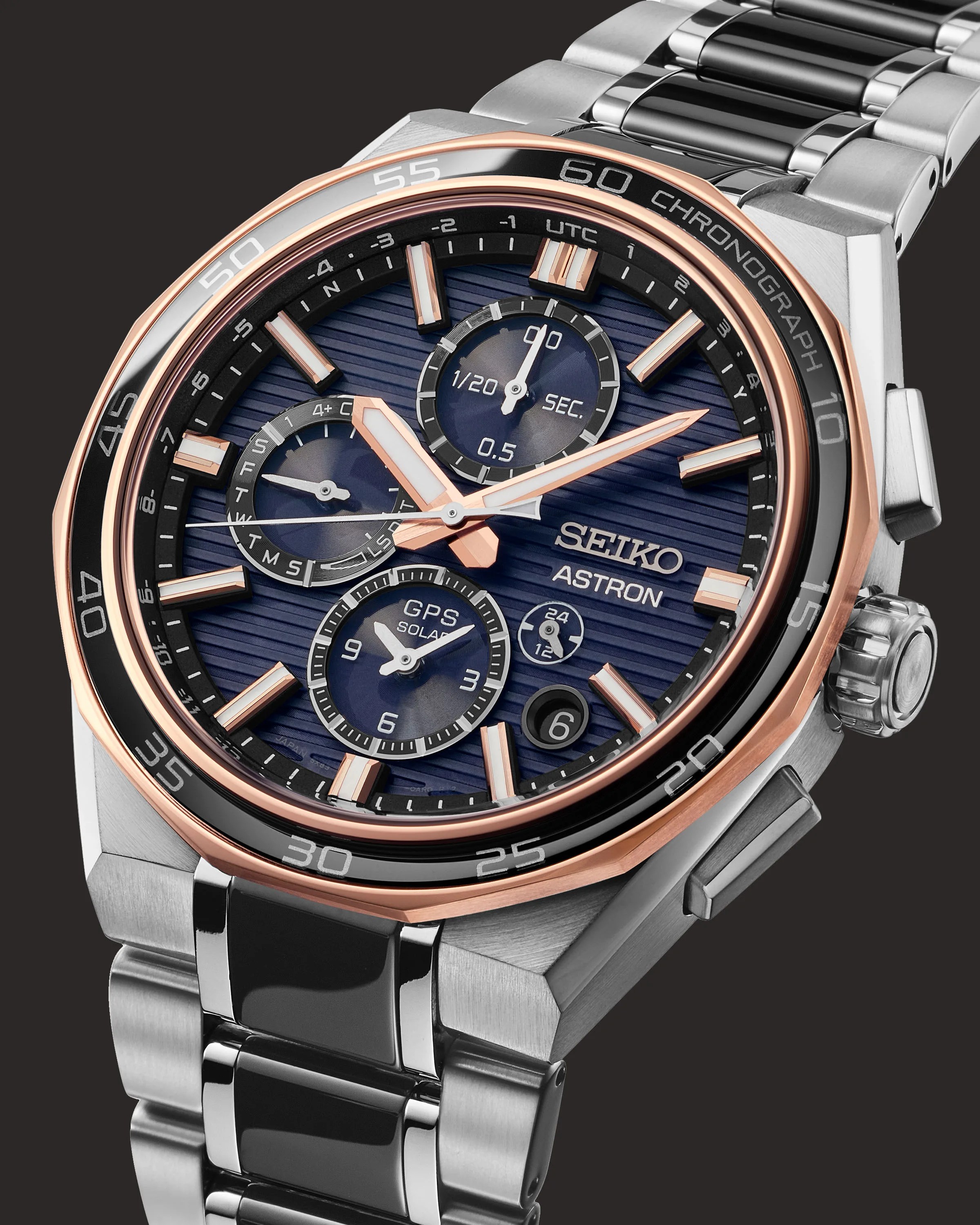 a steel and black Seiko chronograph with a blue dial