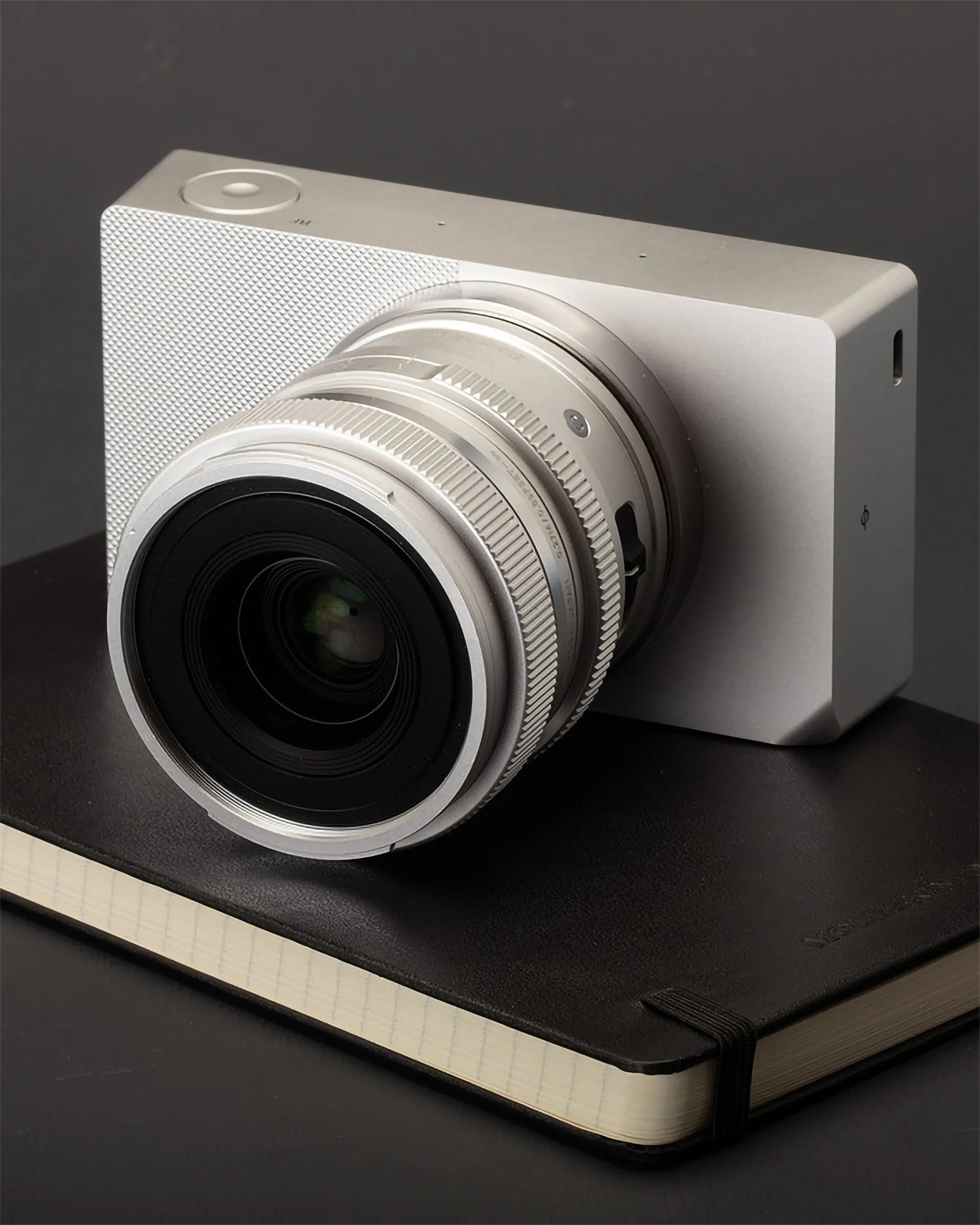 sigma bf camera on top of a moleskine notebook