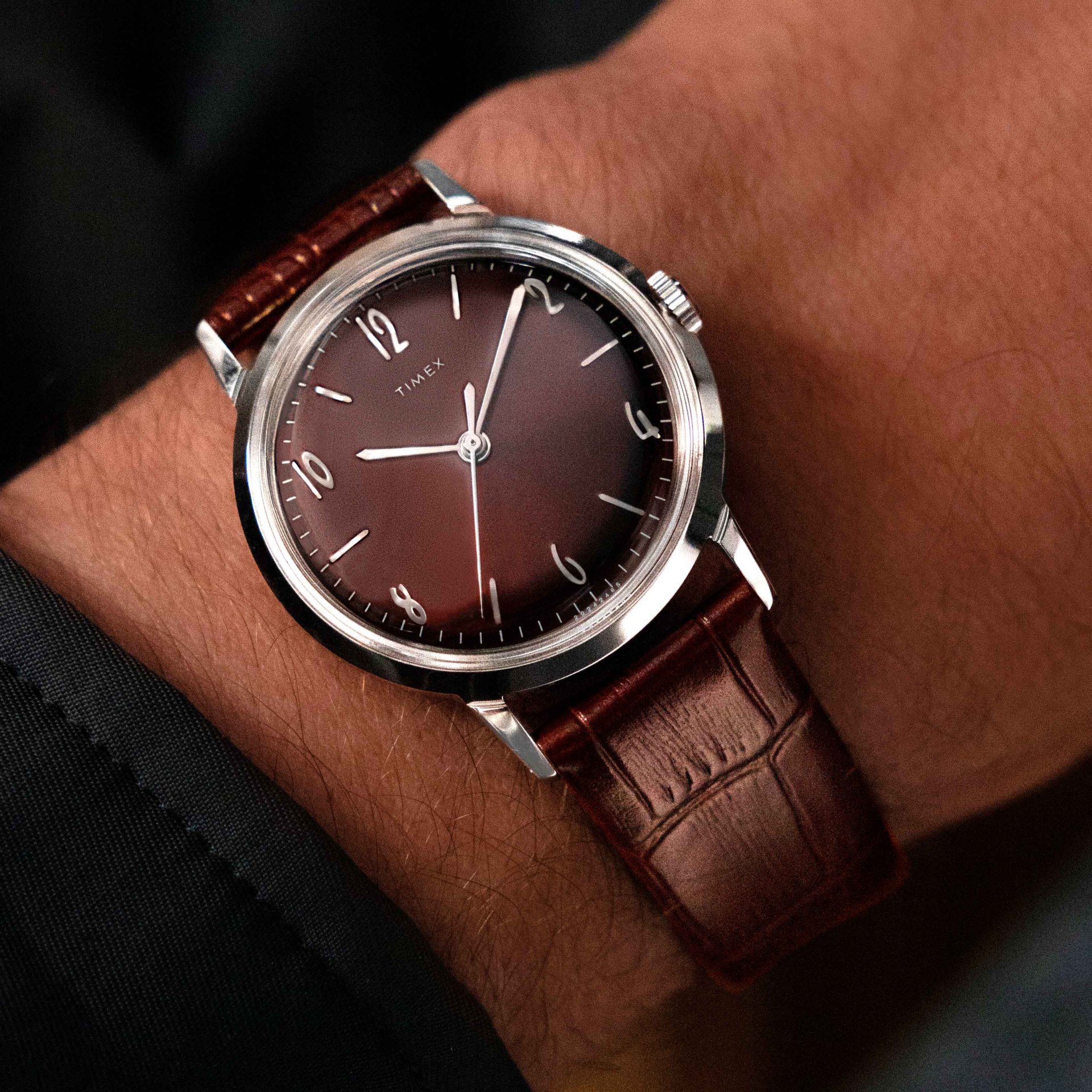 a burgundy Timex Marlin dress watch on a man's wrist
