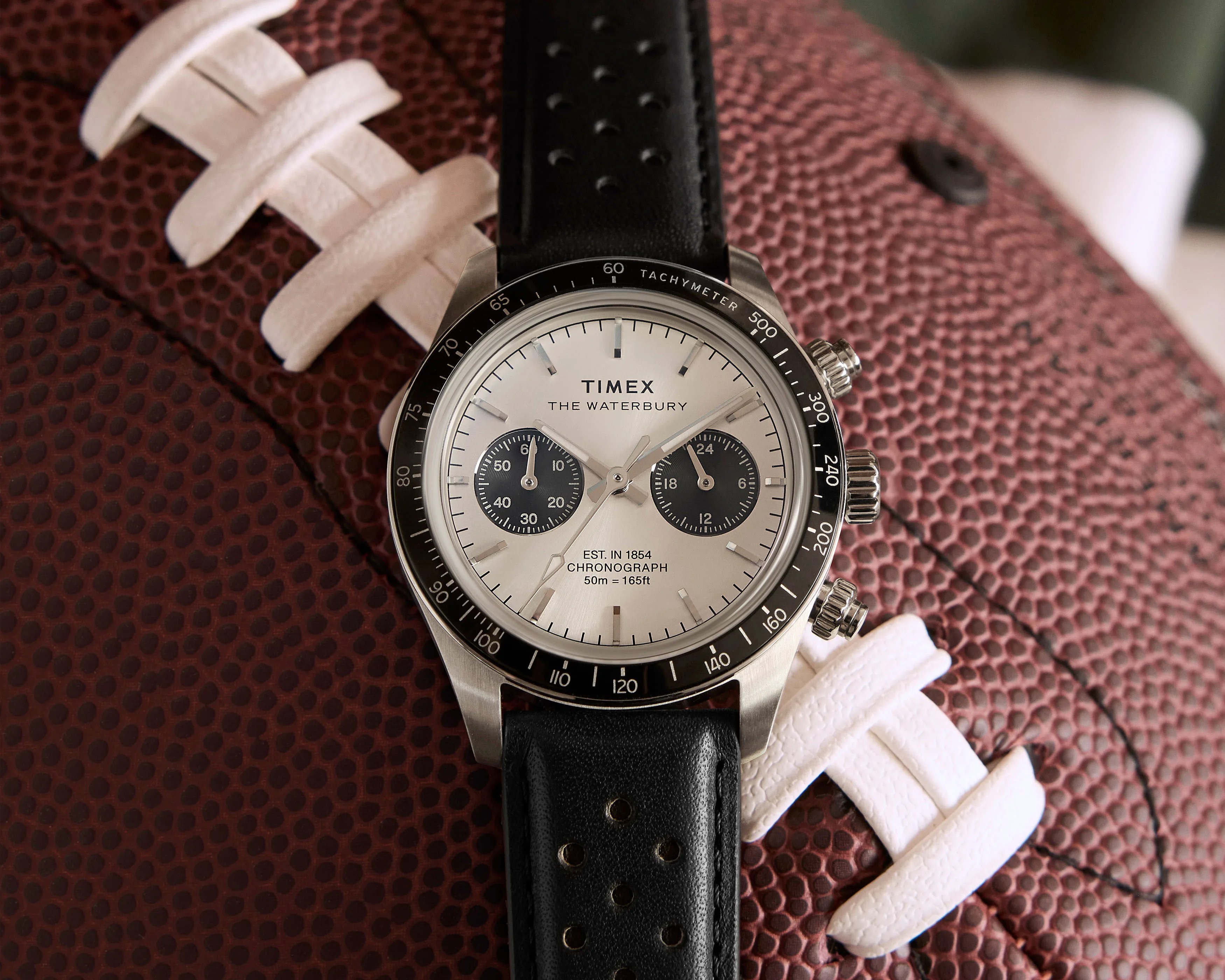 a steel Timex chronograph watch with a black leather strap
