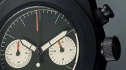 the black case and olive green dial of a Unimatic chronograph watch by Todd Snyder