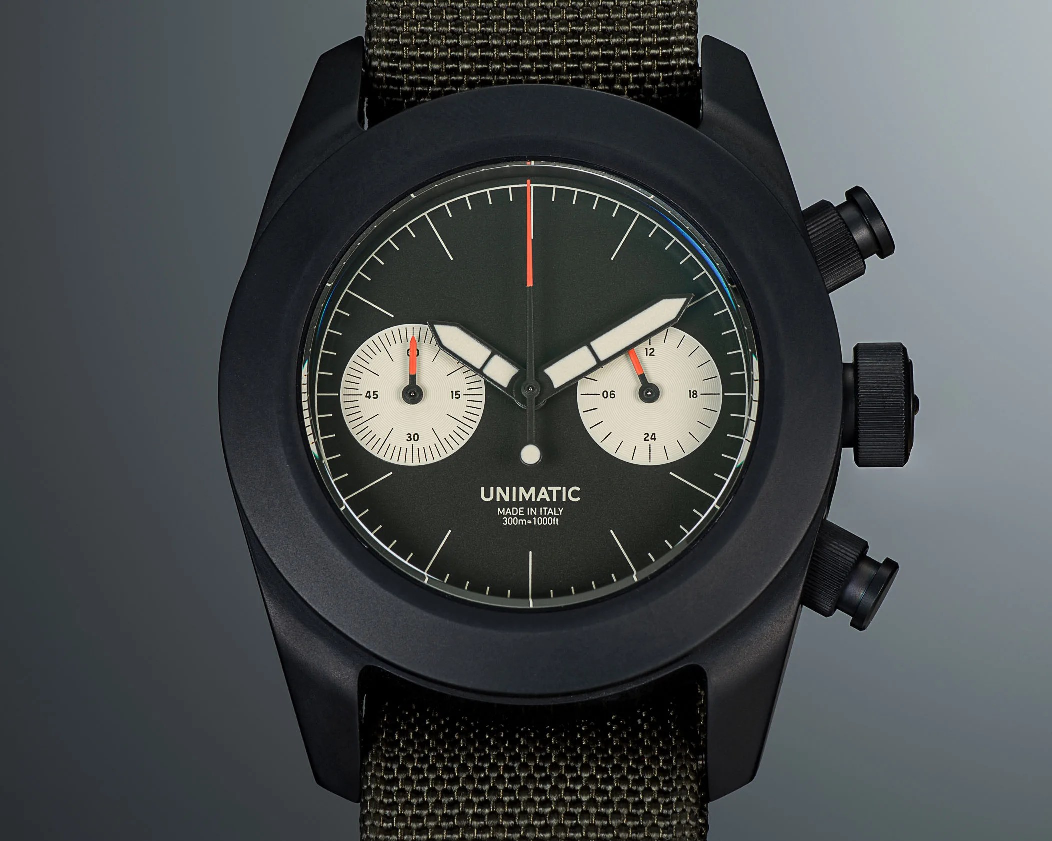 a black Unimatic chronograph watch with an olive green dial