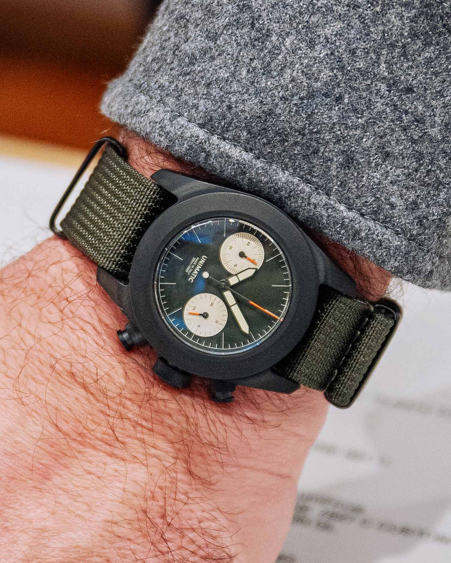 a black chronograph watch on a man's wrist