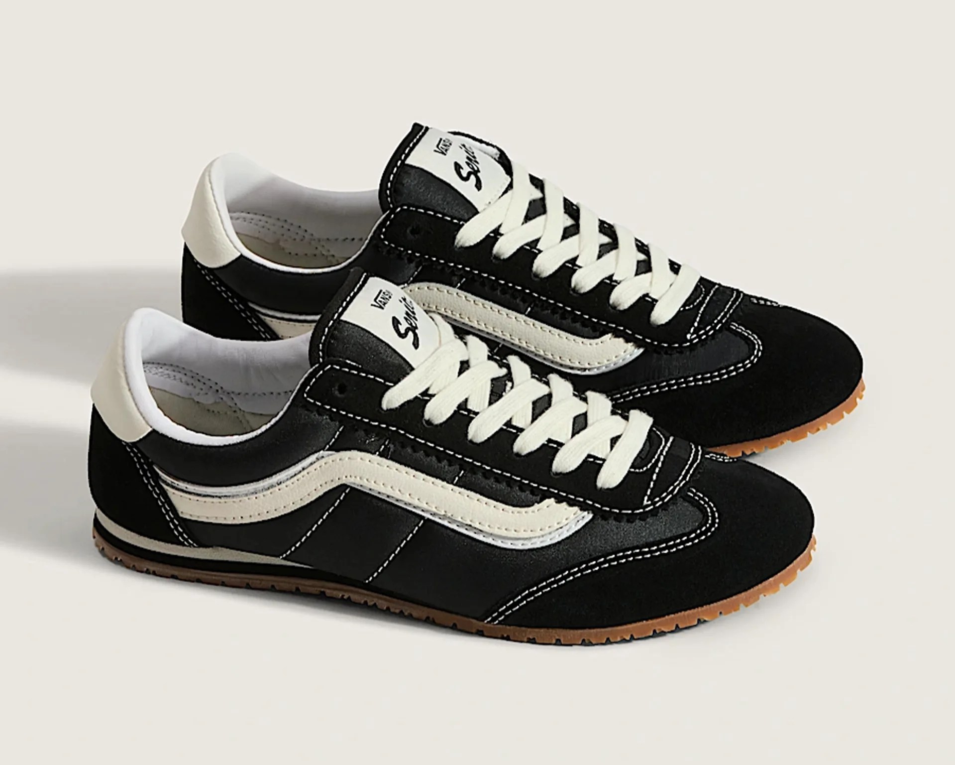 a pair of black Vans sneakers