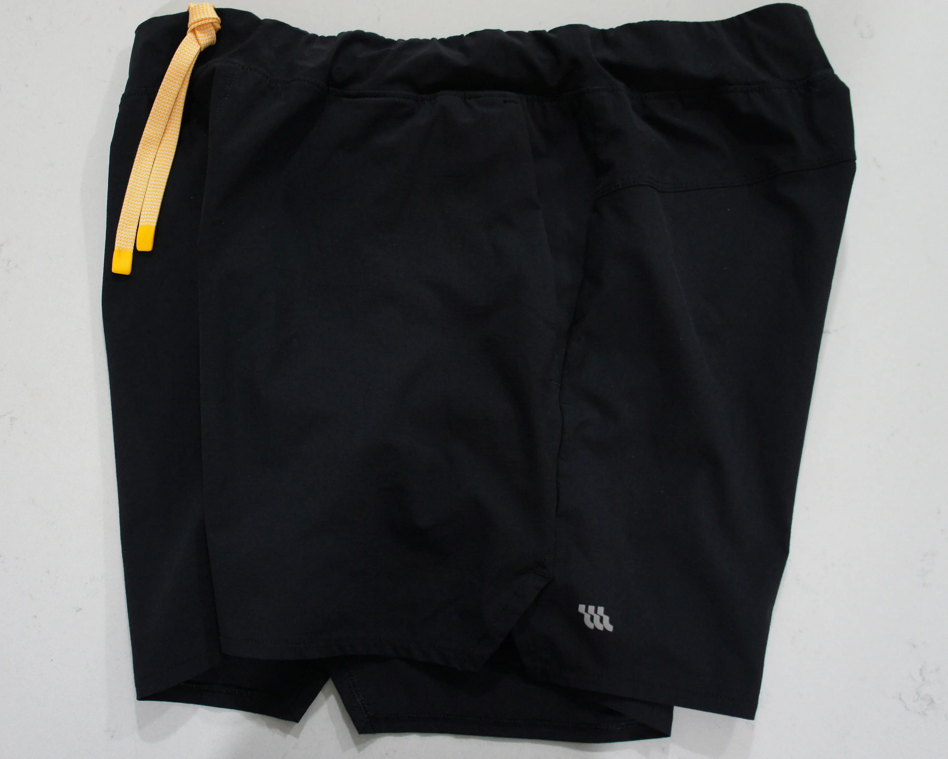 a pair of black Wellen running shorts