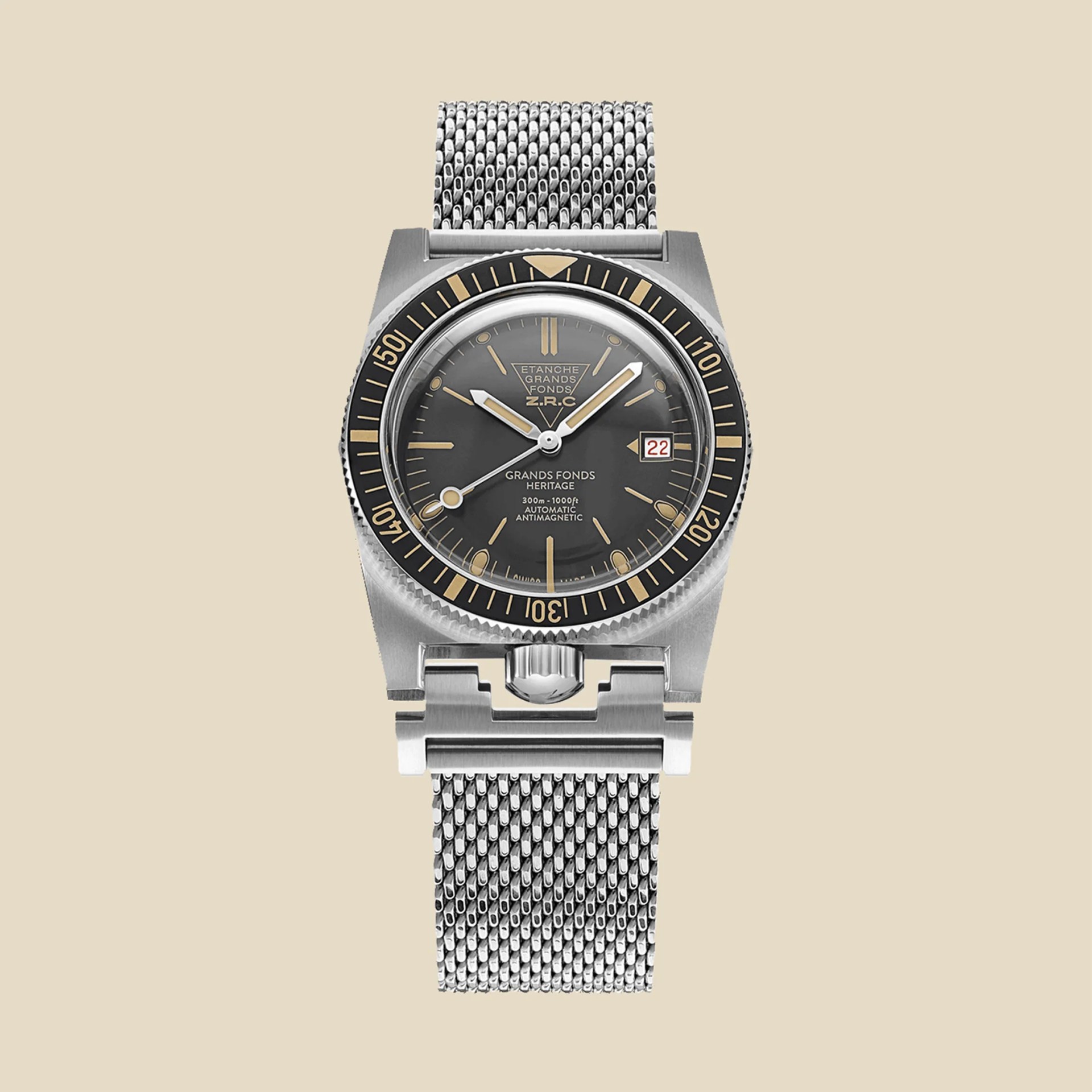 a ZRC dive watch with a black dial and mesh bracelet
