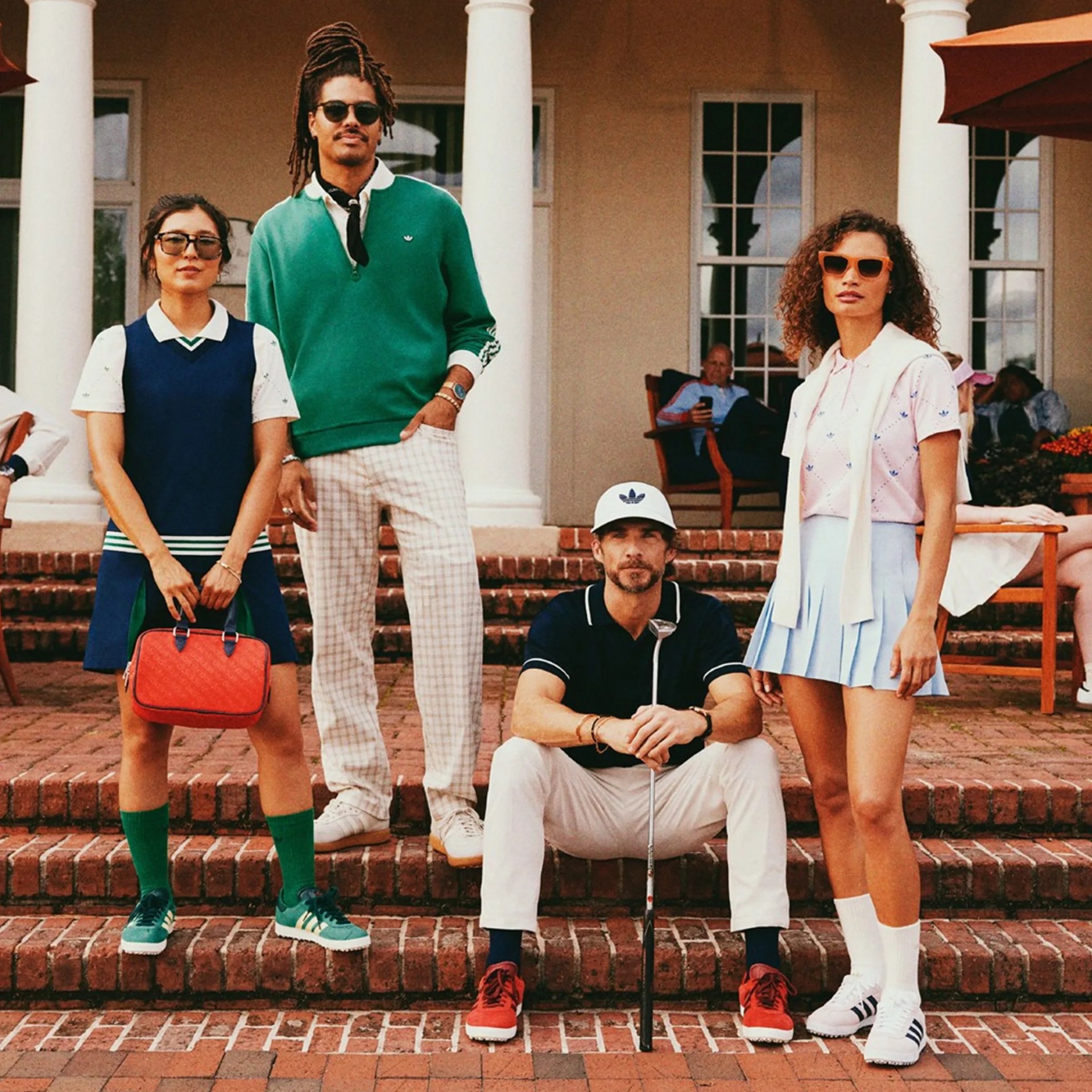 Four models wearing Adidas Originals Golf Collection in front of clubhouse