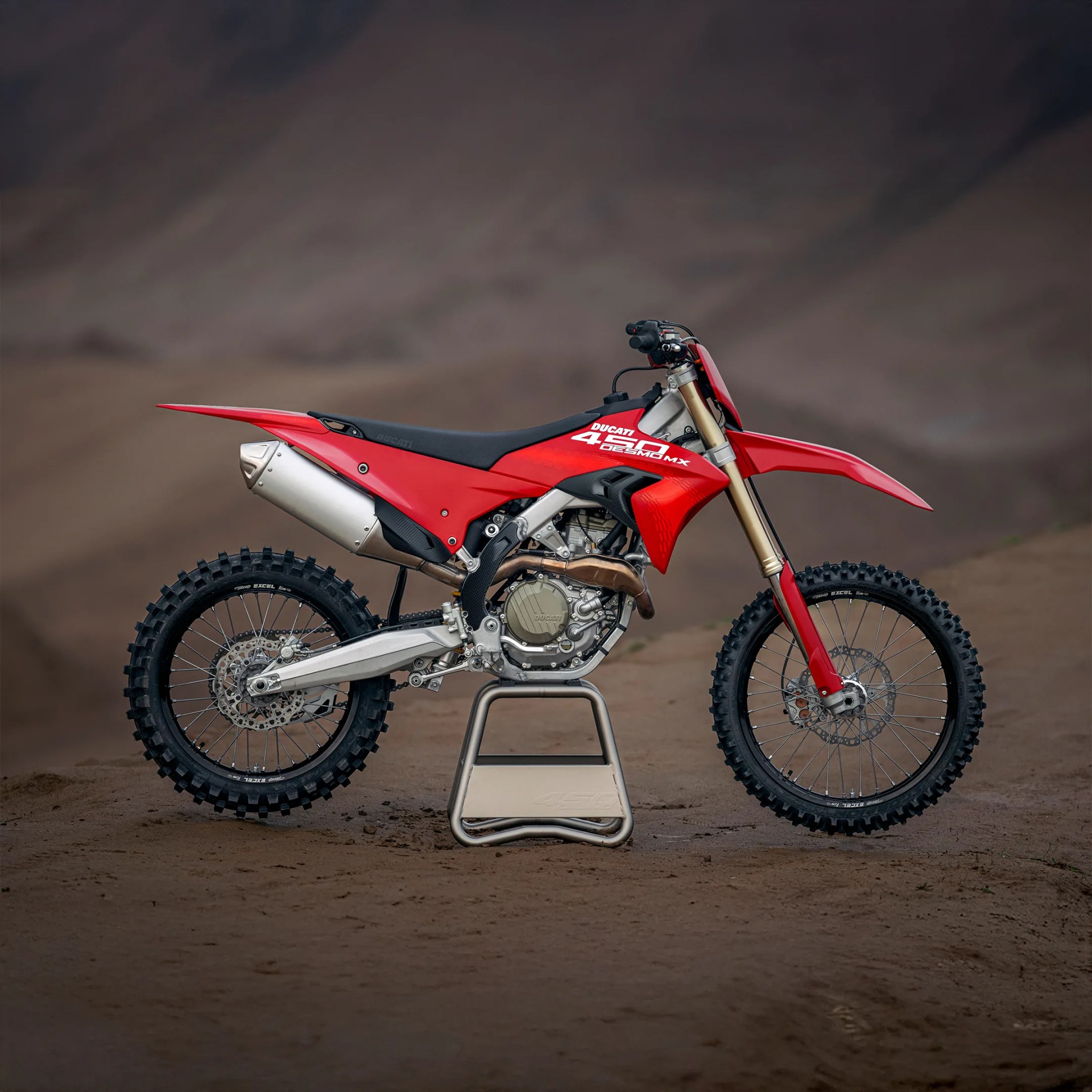 Ducati Desmo450 MX on a stand in the desert