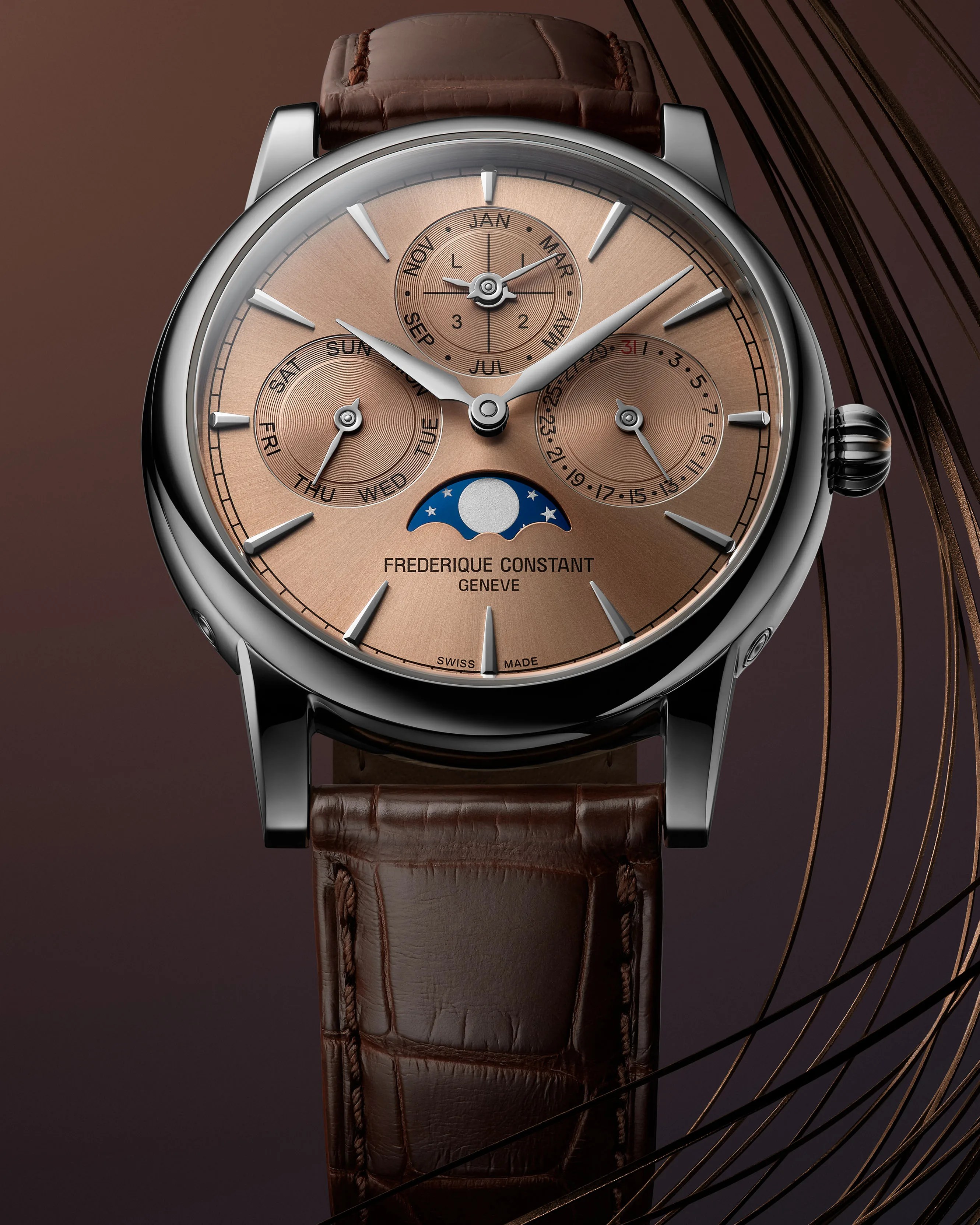 a steel perpetual calendar watch with a brown leather strap