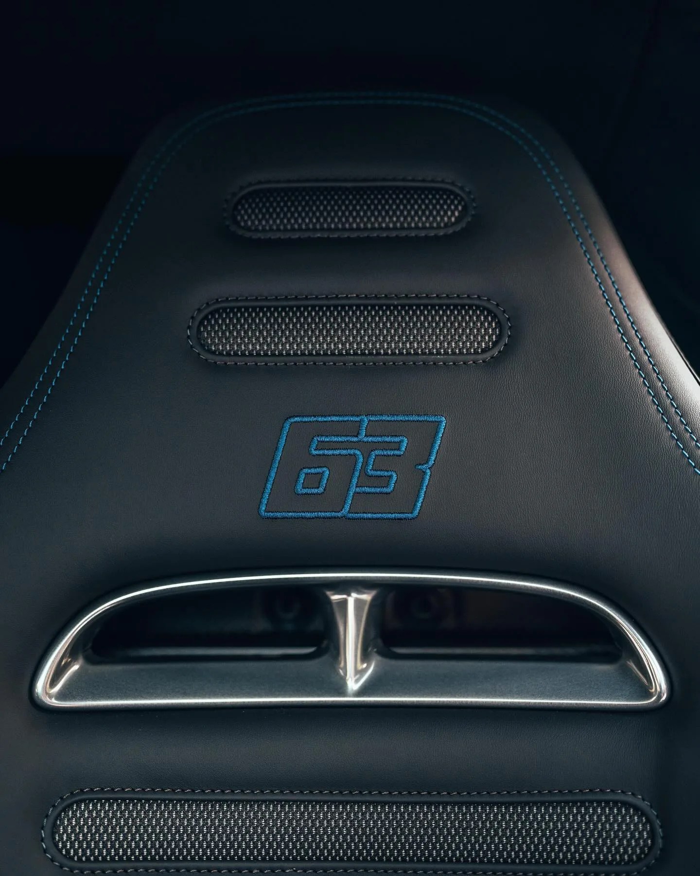 A close-up of the headrest of George Russell's Mercedes-AMG ONE hypercar showing his 63 number embroidered into the leather. 
