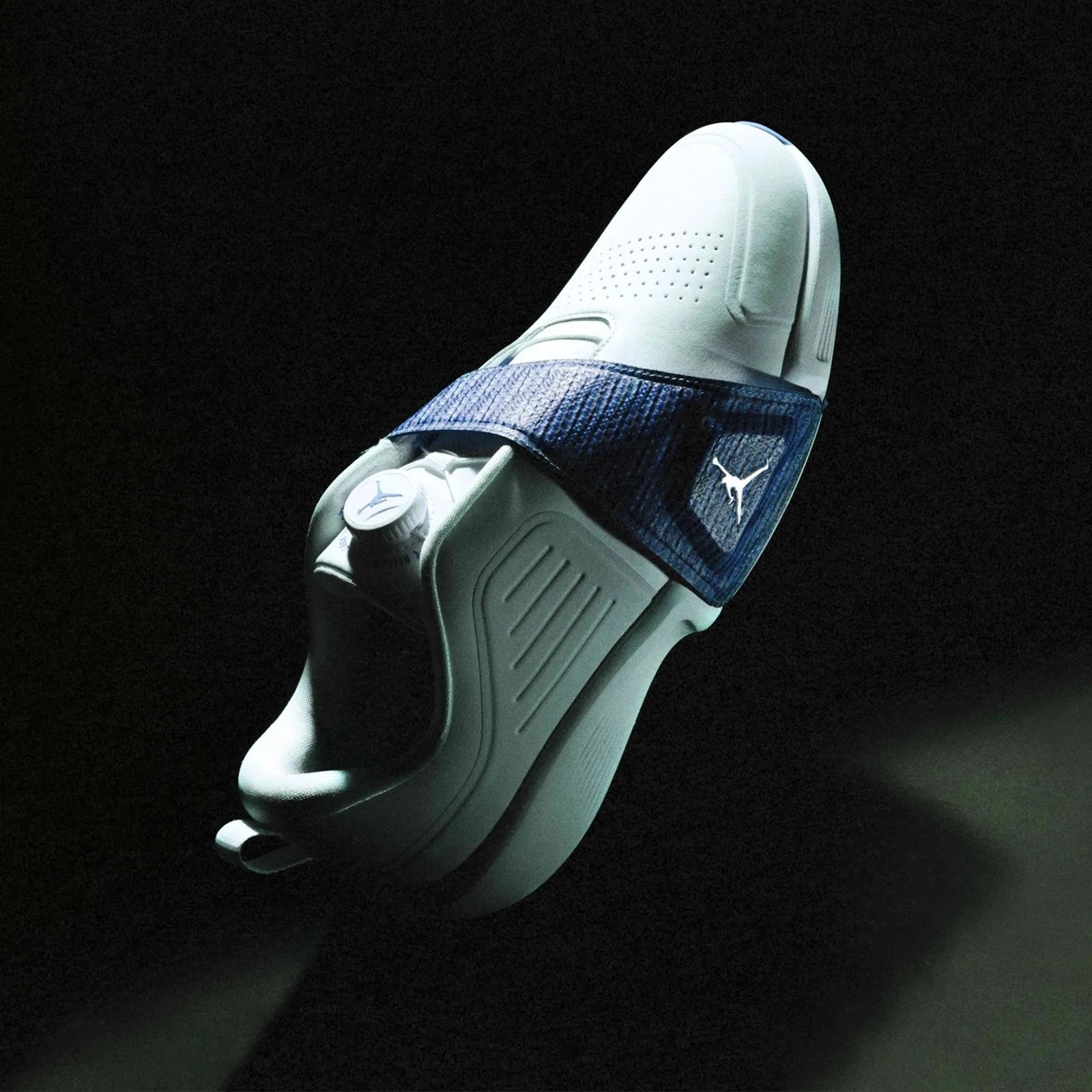 A Jordan Brand Air Rev Golf Shoe floating in a darkly shadowed space