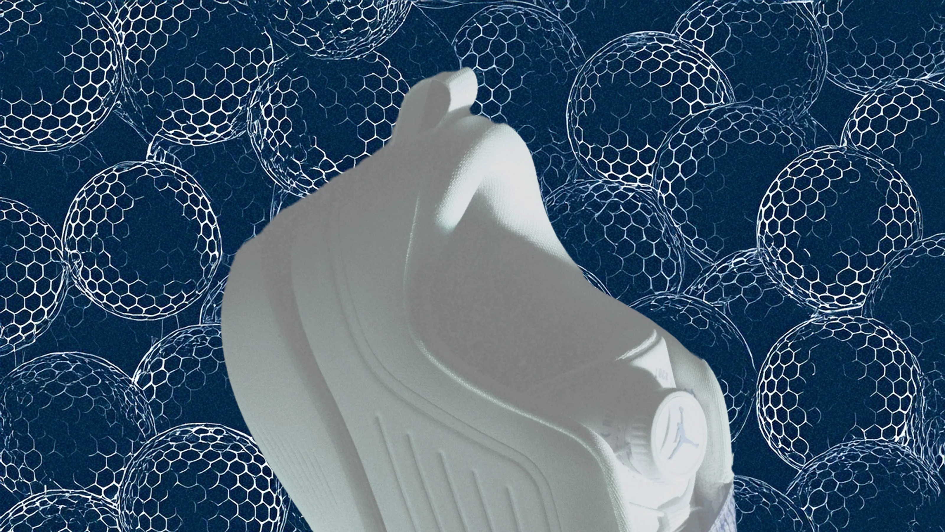 A photo illustration of a Jordan Brand Air Rev golf shoe shown in front of an illustrated pattern of golf balls
