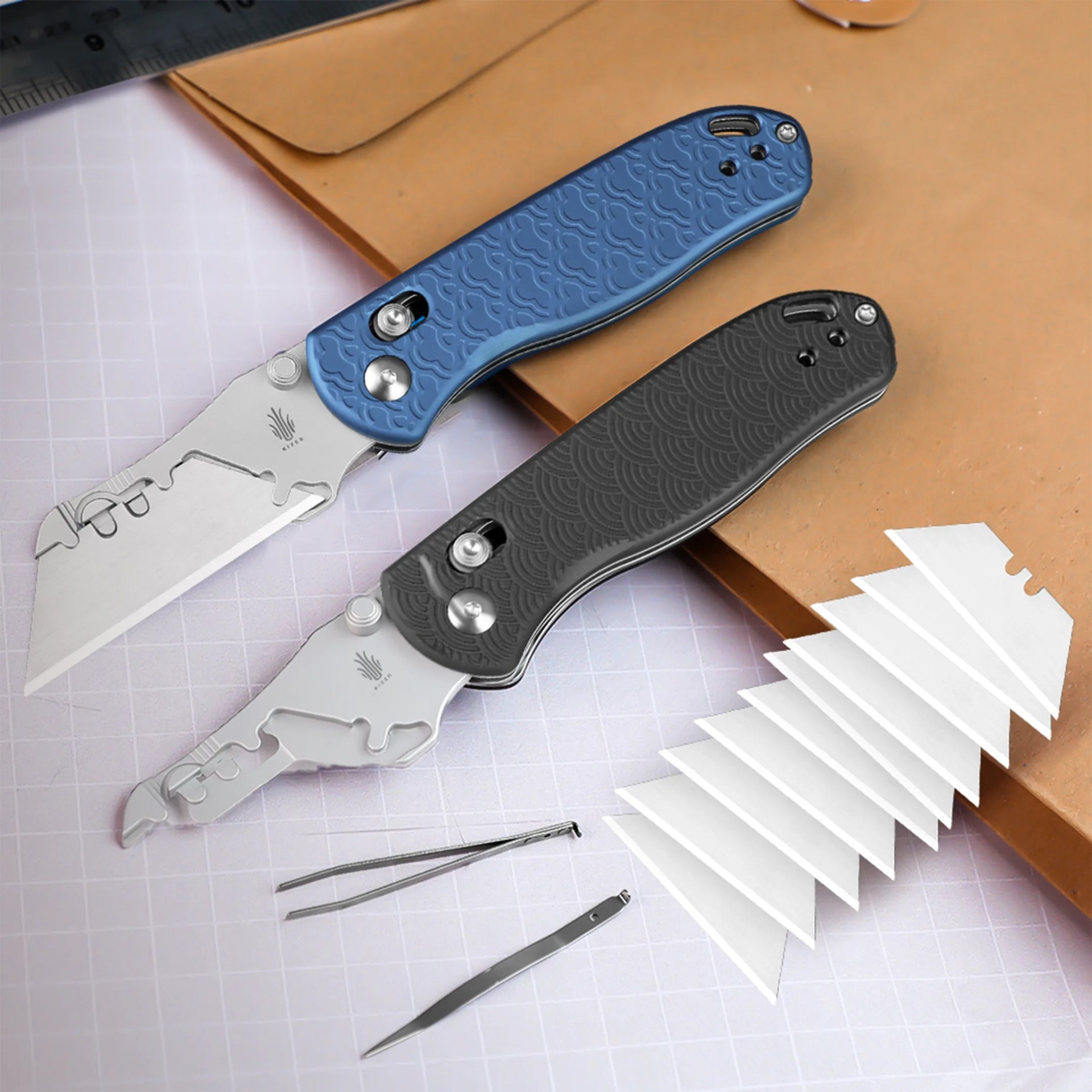 Kizer Drop Bear Utility Knives with tweezers, pick and razors on manilla folder and desk