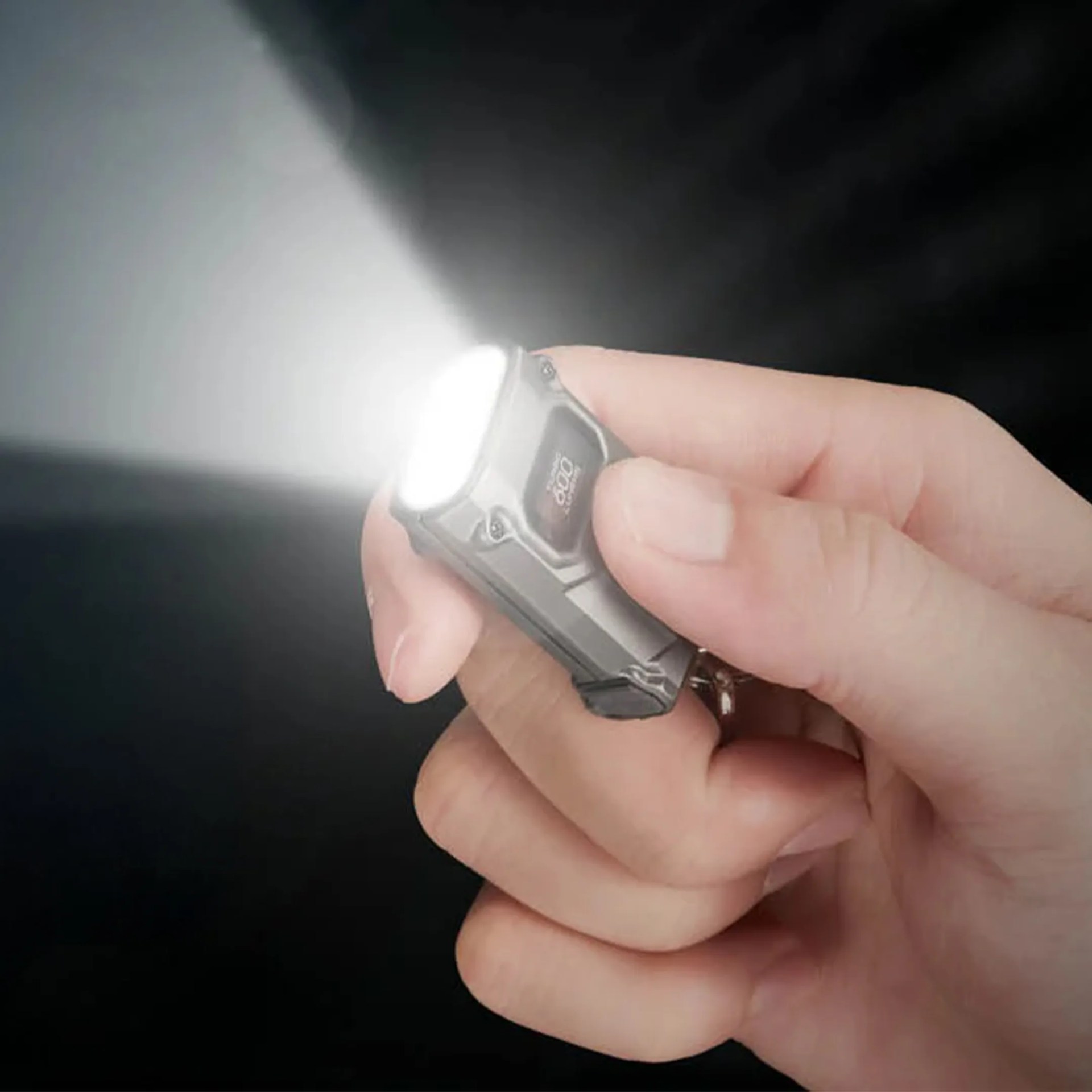 Nitecore TINI 3 Keychain Flashlight in hand on Pulse mode