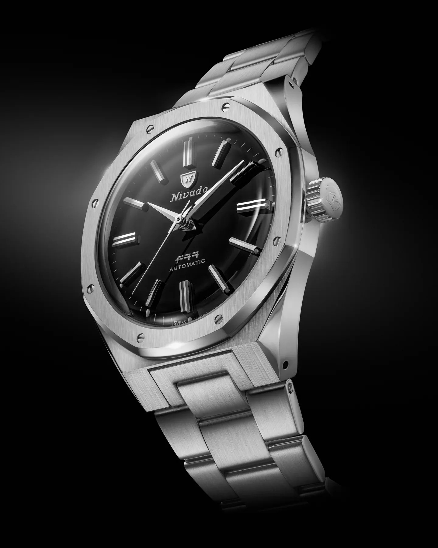 The Nivada Grenchen F77 MarkII SST in black is shown against a black background