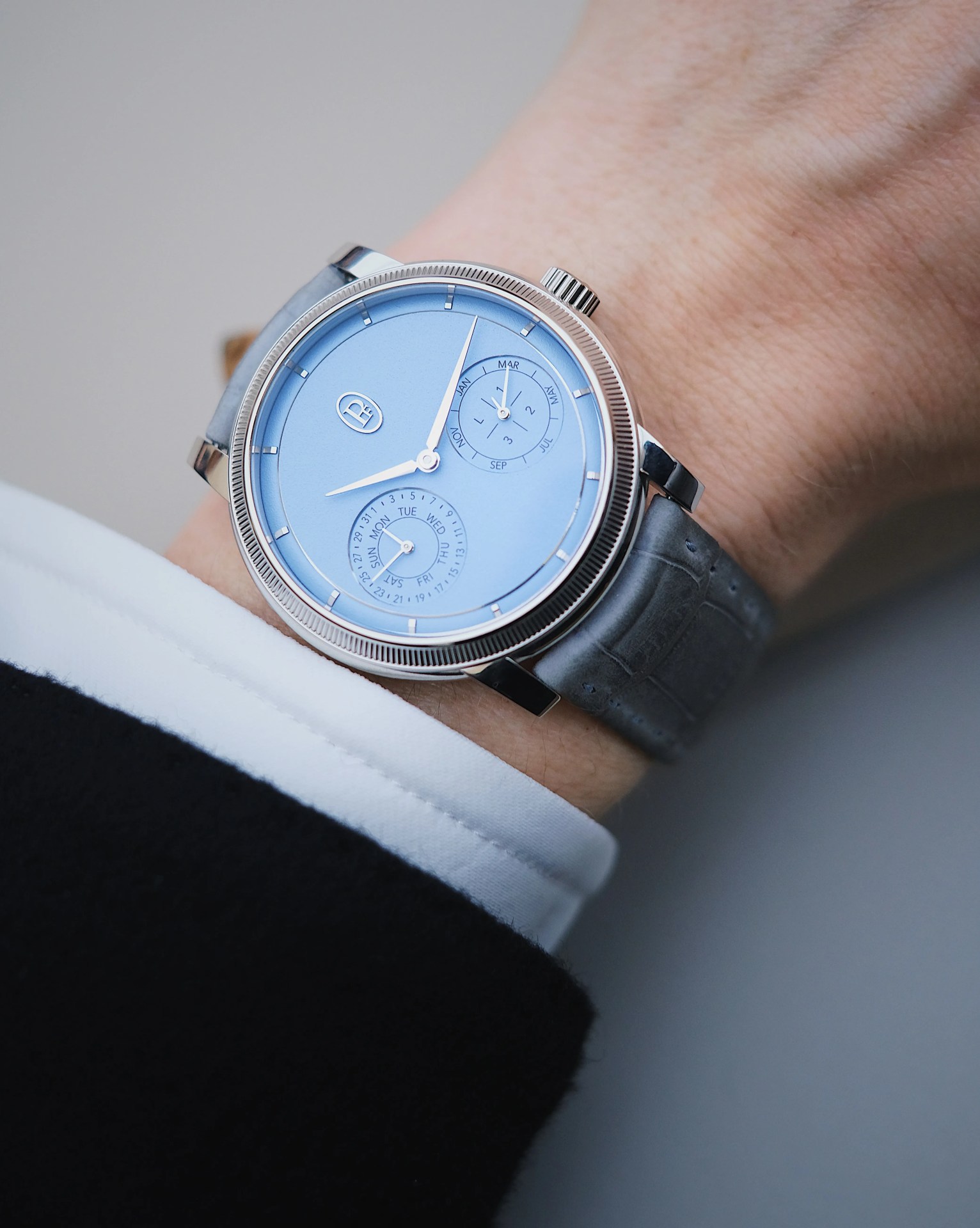 The Parmigiani Toric Quantieme Perpetual watch worn on a model wrist.