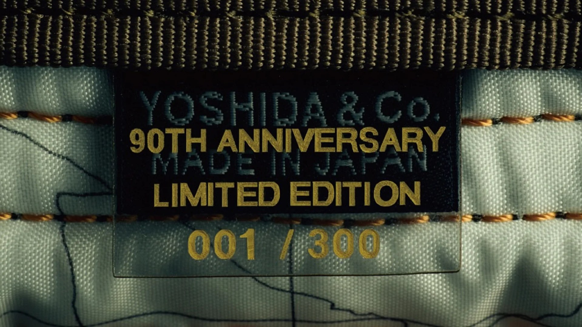 Porter Yoshida and Co Tanker Coyote 90th Anniversary Bag Collection tag closeup