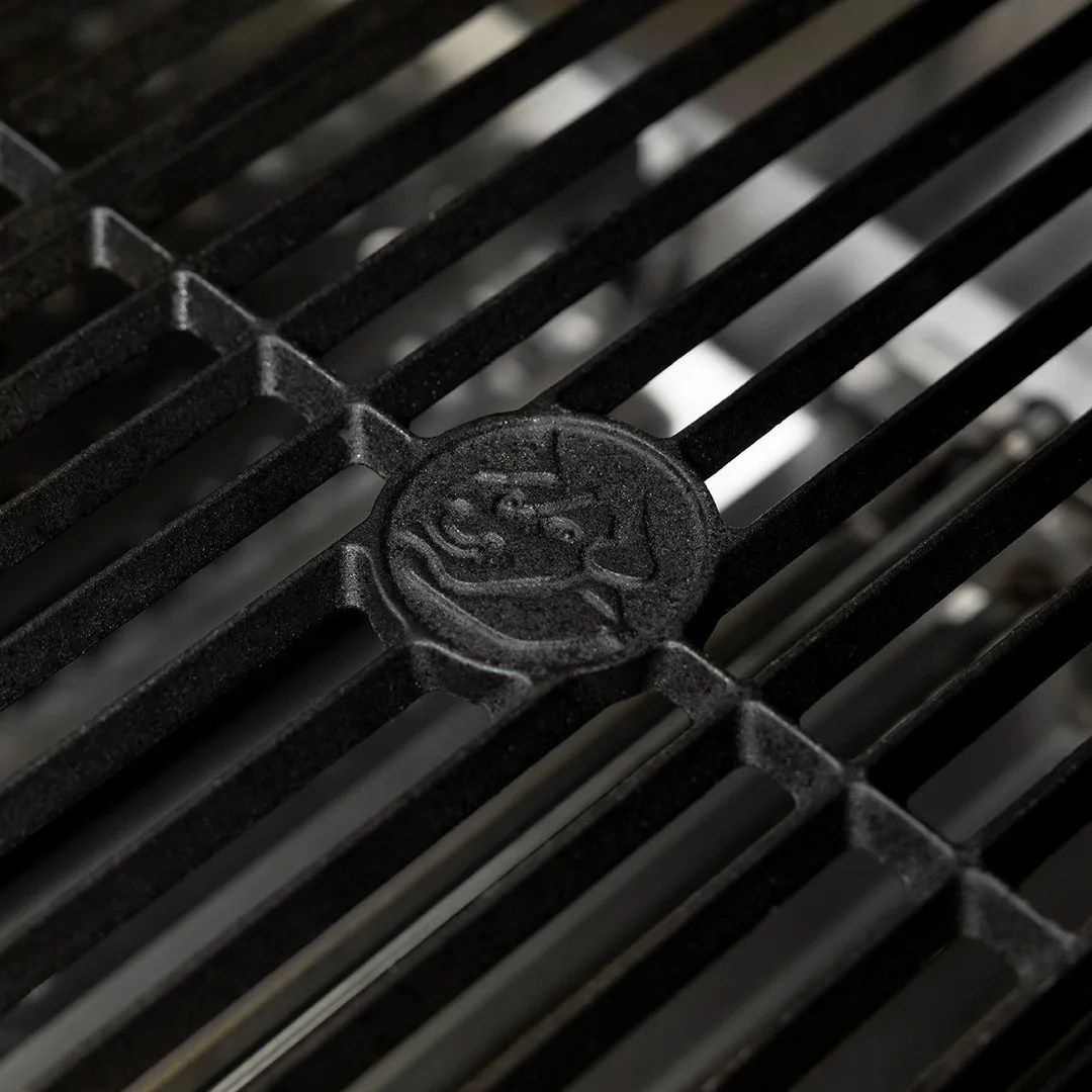 A close-up of the grilling grate on the Recteq X-Fire Pro 825 grill, which includes a circular bull with horns logo stamped in the cast iron.  