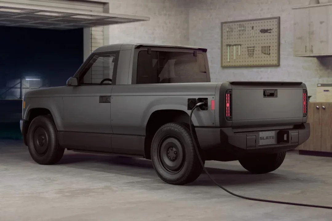 The Slate Auto Blank Slate EV Truck charging in a garage.