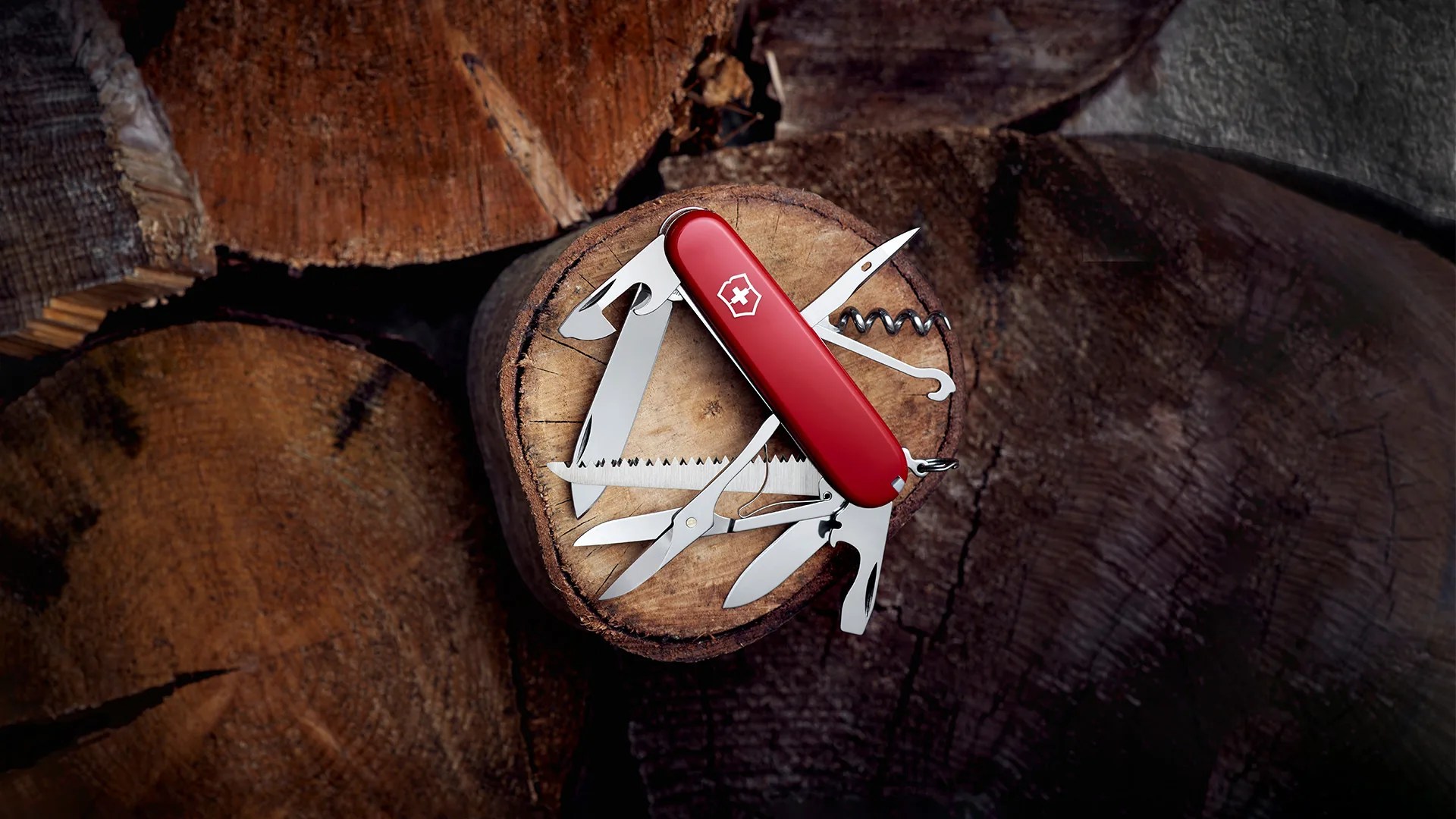 Victorinox Huntsman Multi-Tool resting on wood stump