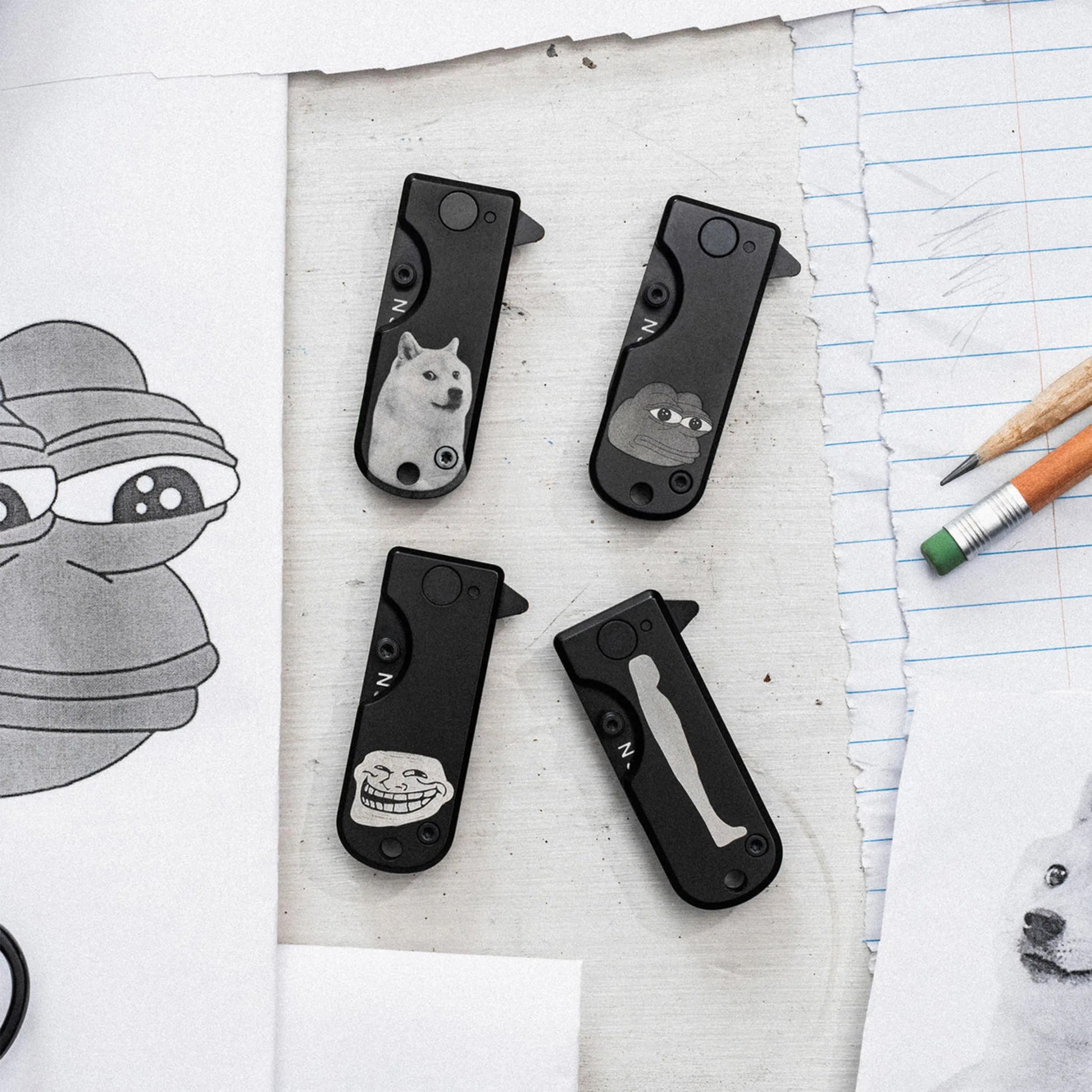 WESN The Meme Line 4-Knife Bundle sittong on desk next to papers and pencils