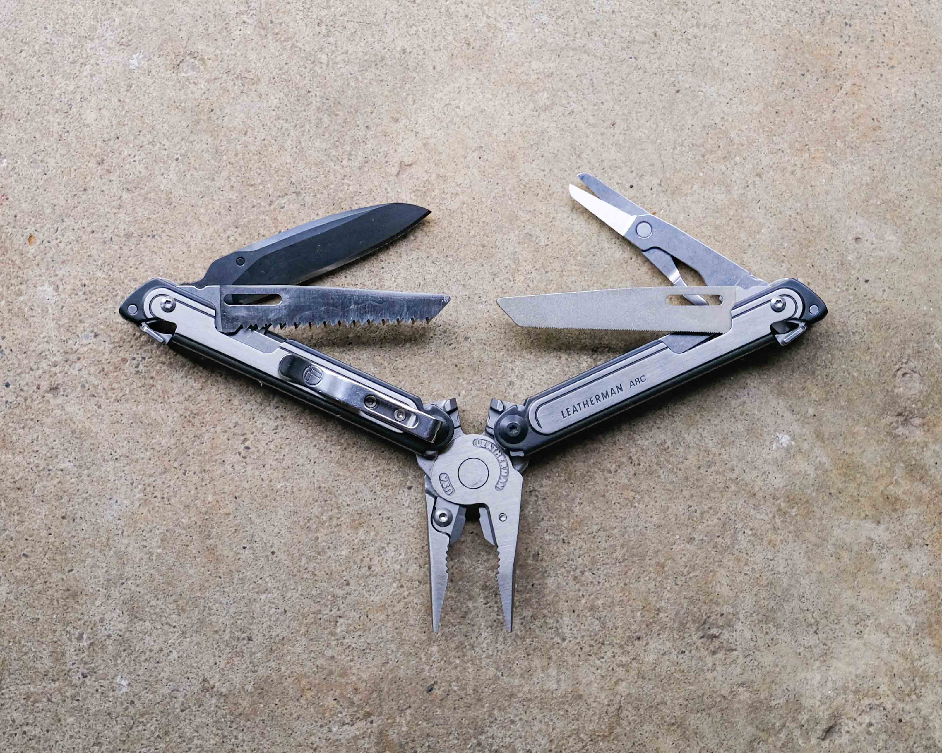Leatherman multi-tool on concrete backdrop