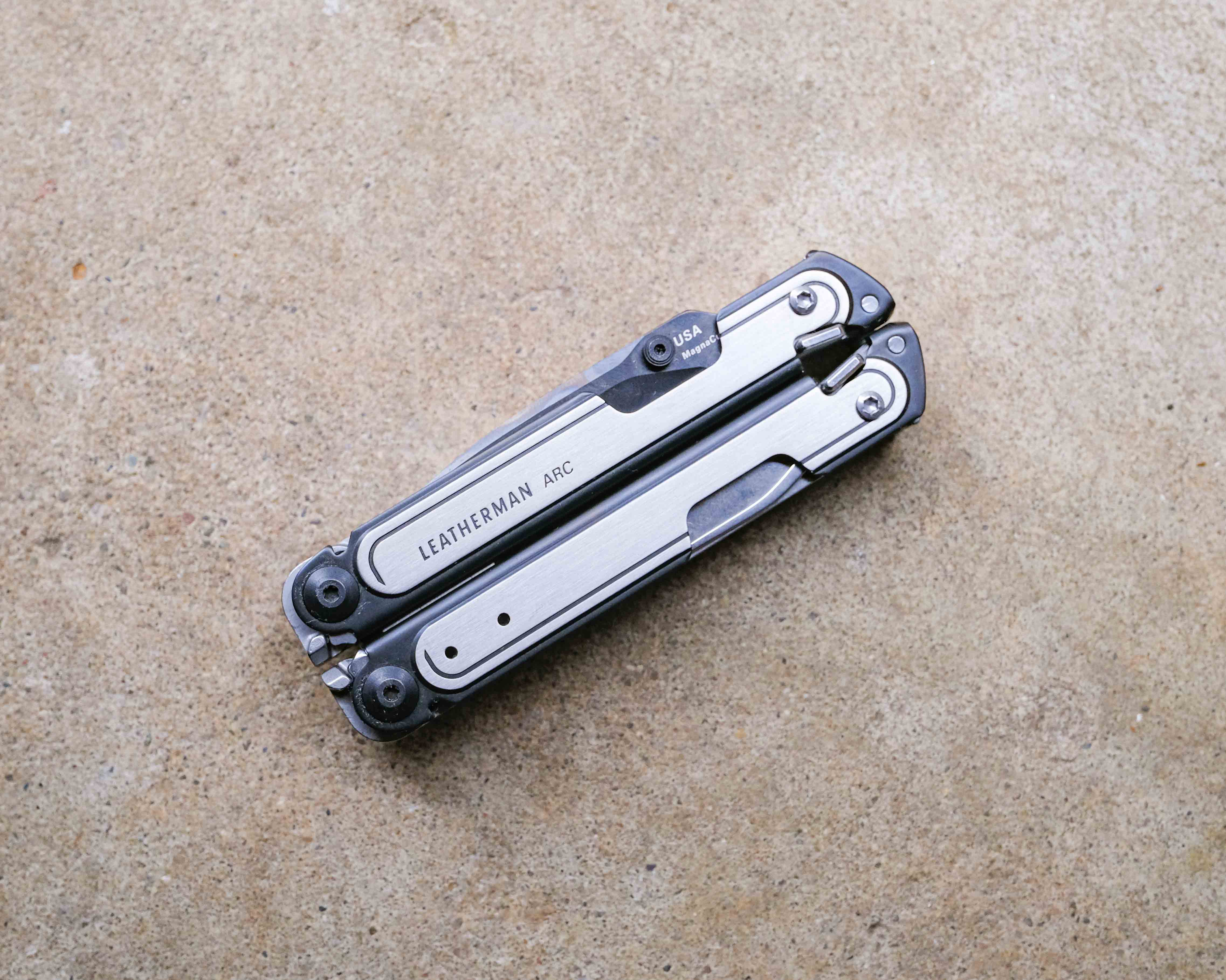 Leatherman multi-tool on concrete backdrop