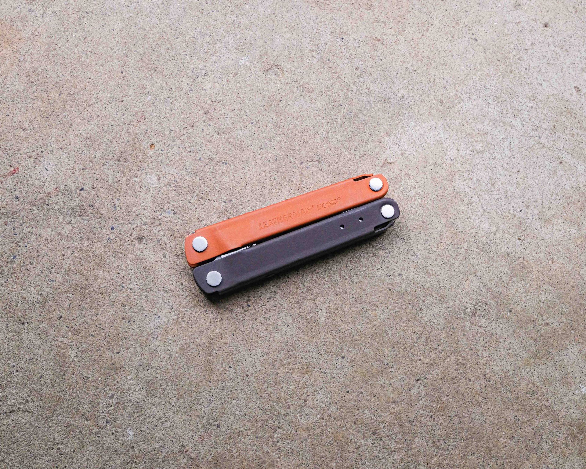 Leatherman multi-tool on concrete backdrop