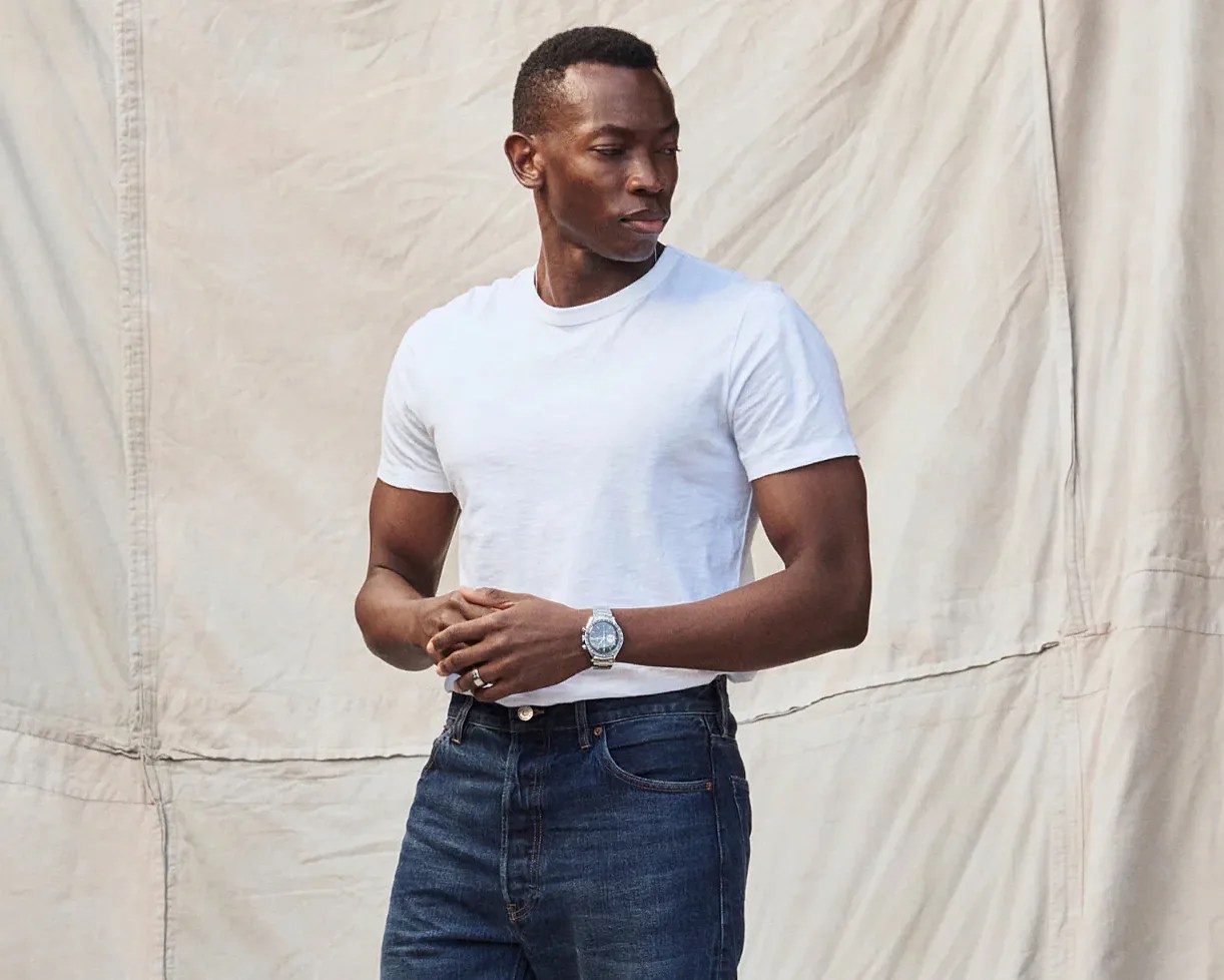 a man wearing a white tee and jeans