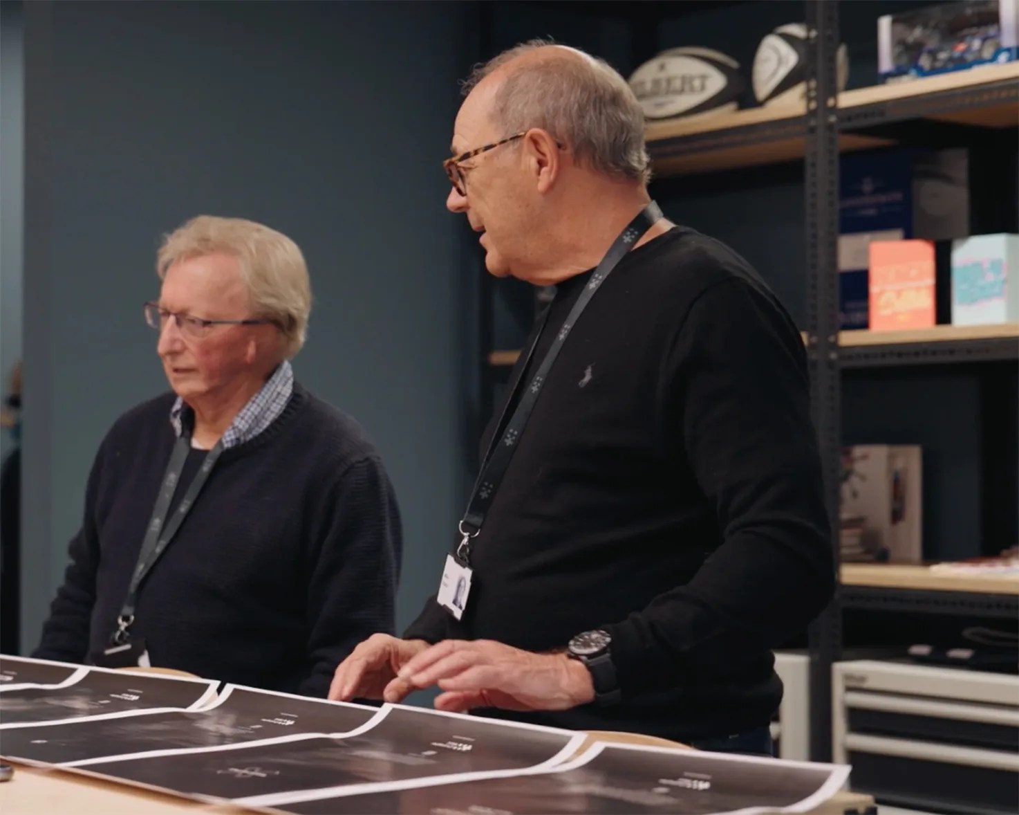 two men standing at a desk
