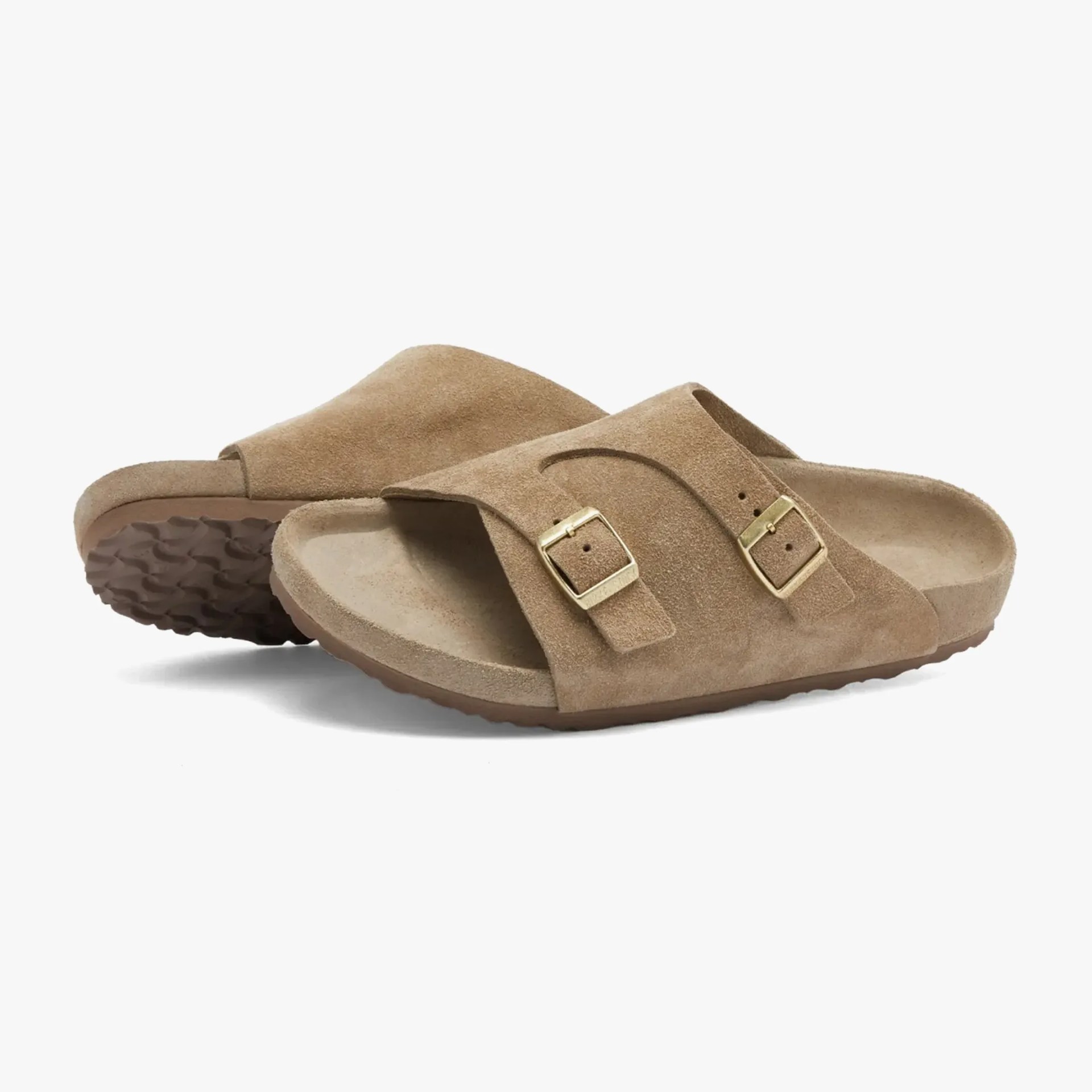 a pair of suede slide sandals