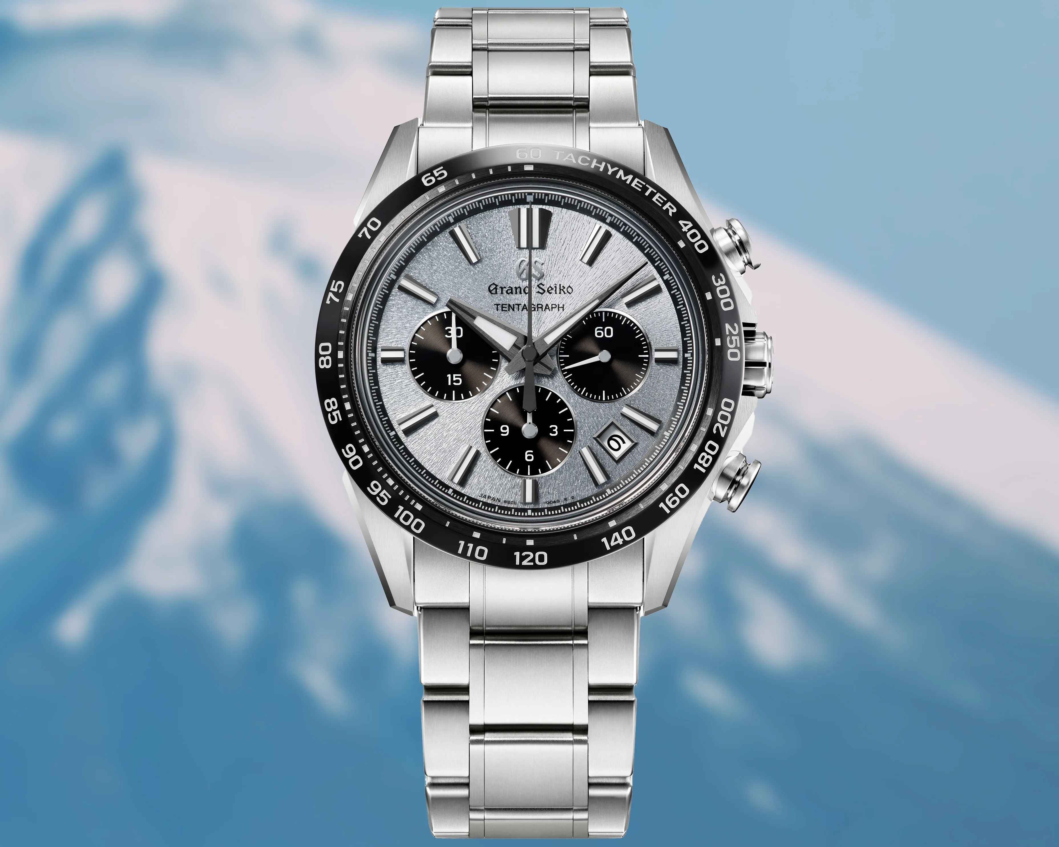 a Grand Seiko chronograph with a mountain background