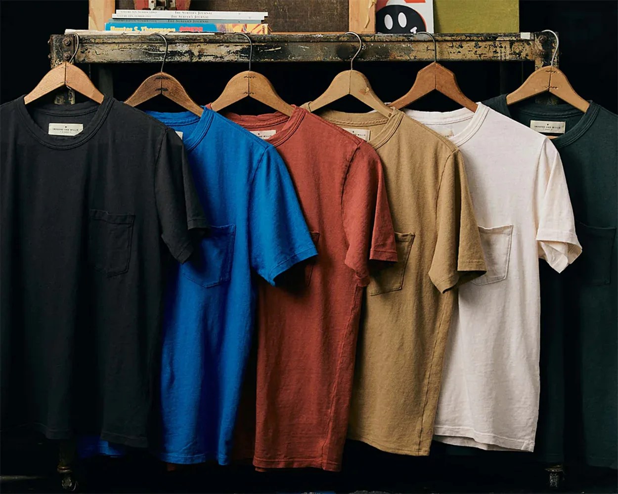 a set of t-shirts hanging on a shelf