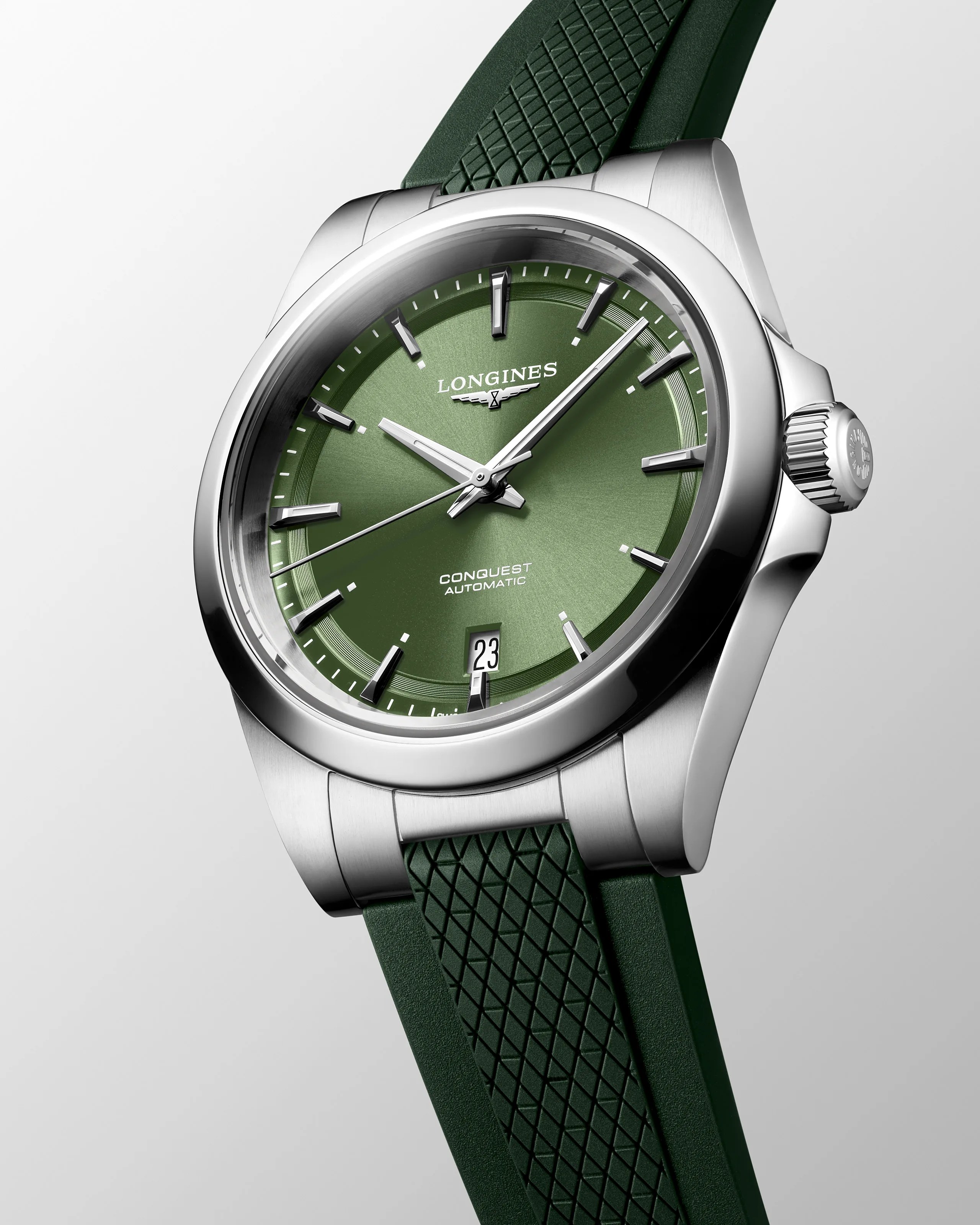a steel watch with a green dial and strap
