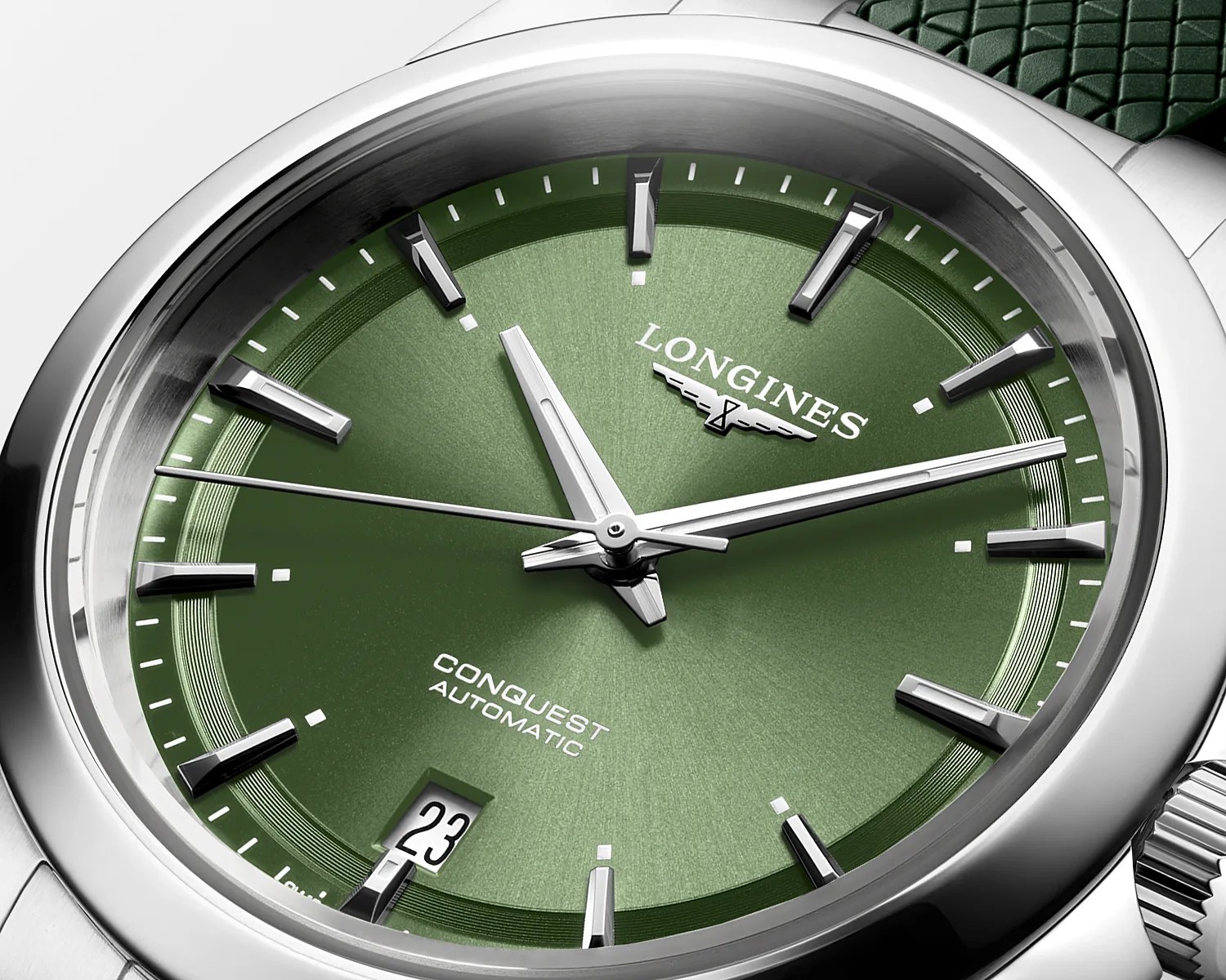 a steel watch with a green dial
