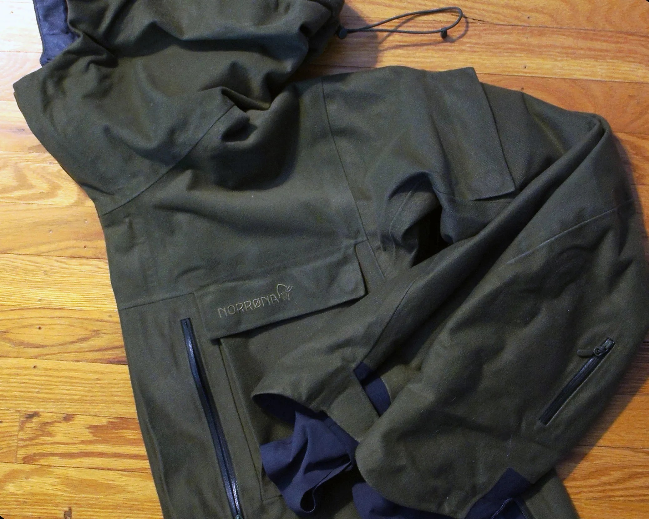 a green jacket folded up on the ground