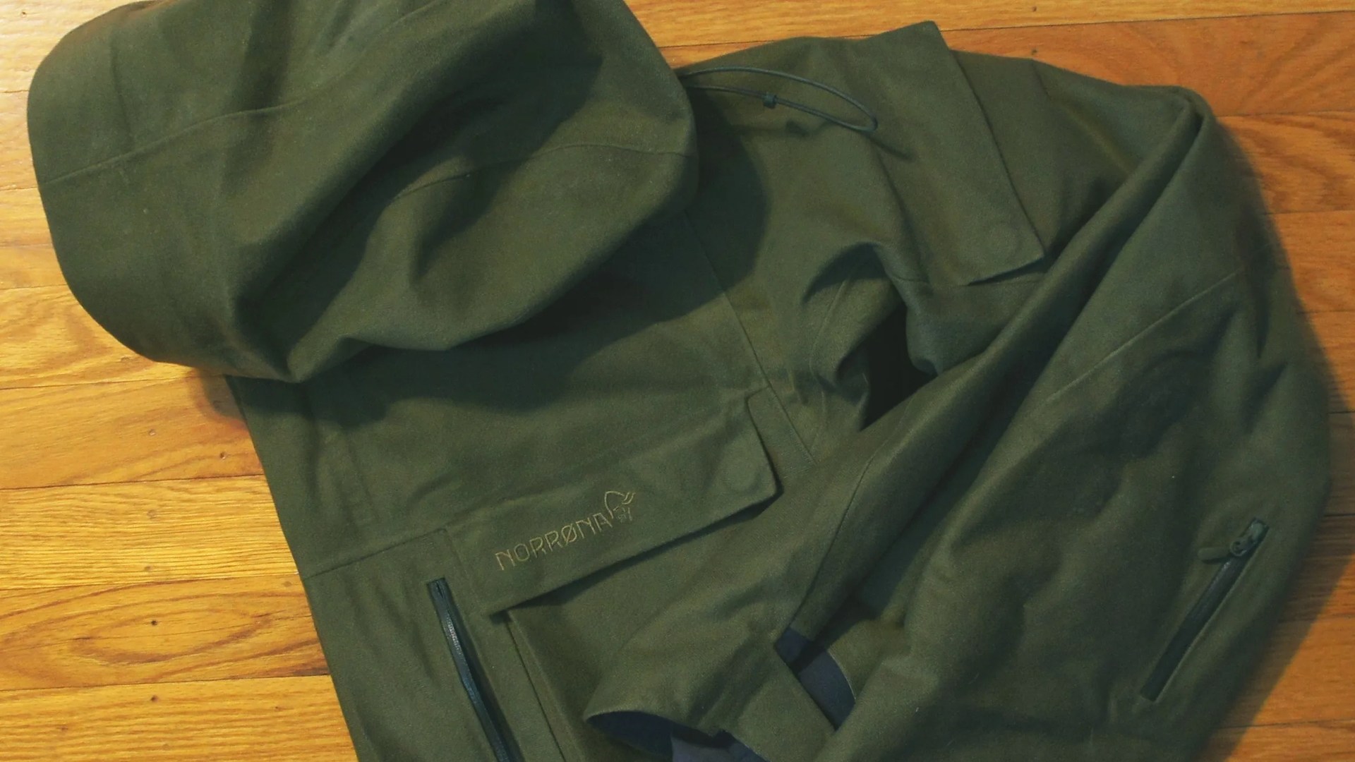 a green jacket folded up on the ground